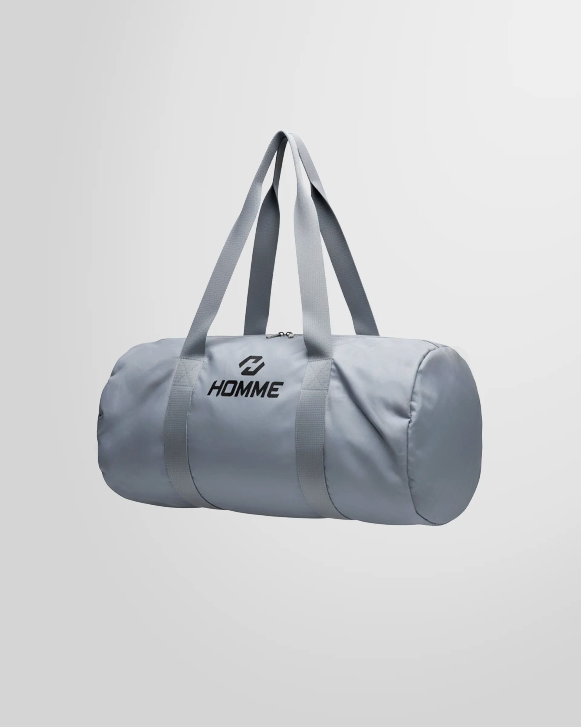 Side profile of the grey Not Guilty Homme sport bag, emphasizing its unstructured, cylindrical form.