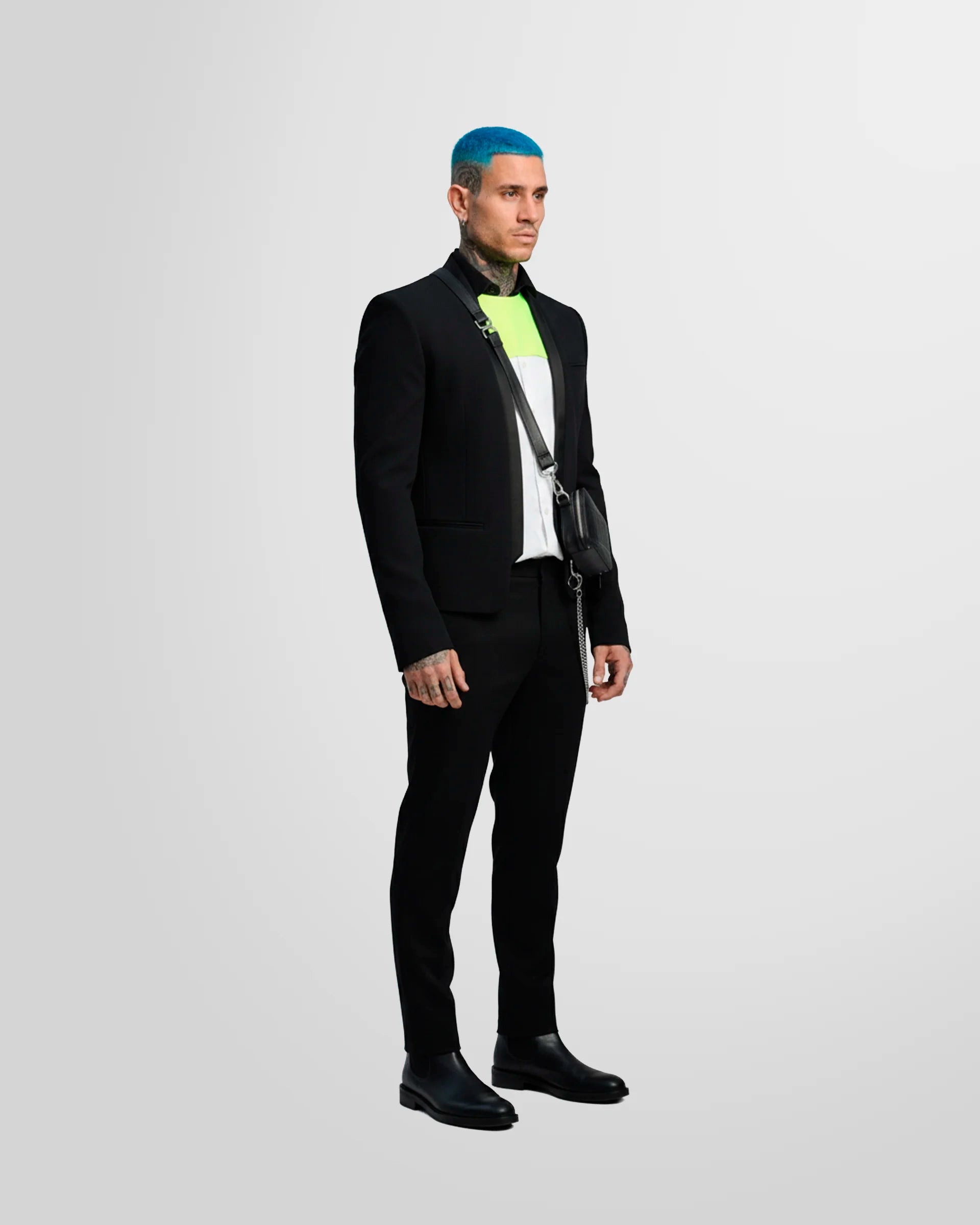 View from the side of a model wearing the Not Guilty Homme blazer, showcasing its straight fit, cropped length, and open-front styling.