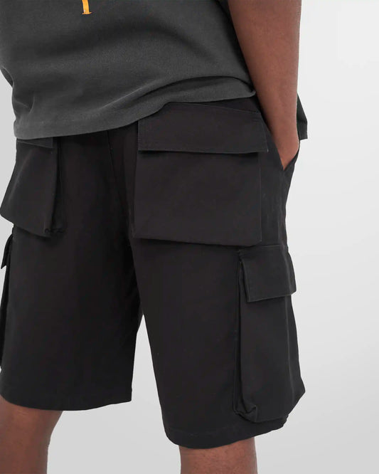 Side profile of the black Represent Baggy Cargo Shorts, highlighting the oversized 3D cargo pocket and metal logo bar.
