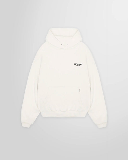 Front view of the Represent Owners' Club Hoodie in Flat White, showing the chest logo.