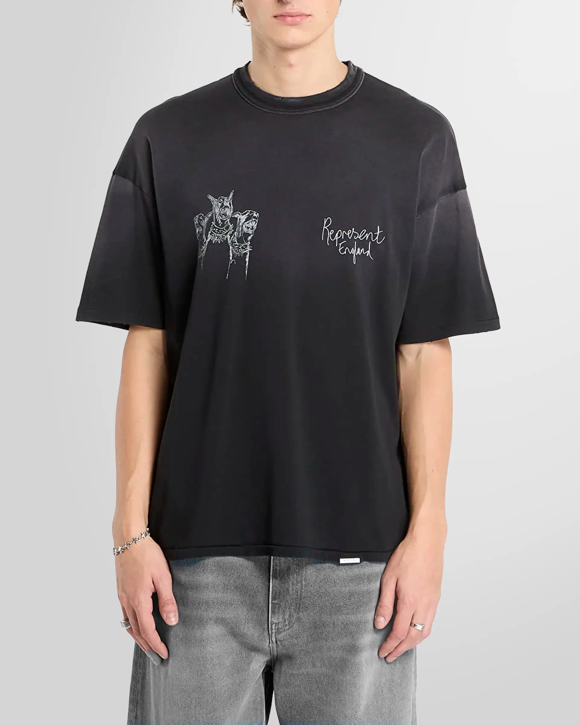 Model wearing the aged black Thoroughbred tee, front view, oversized fit.