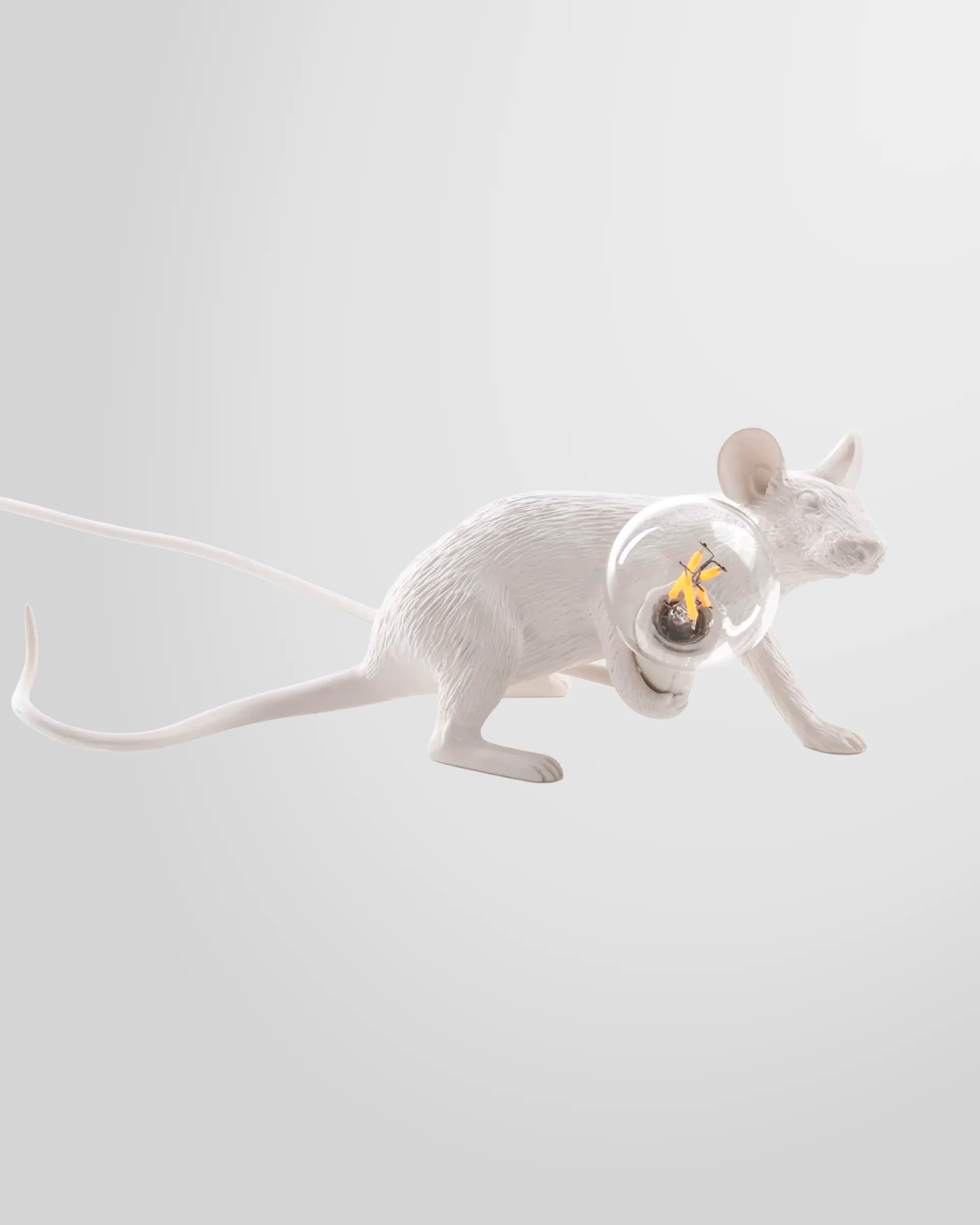 A close-up detail of the white resin Seletti Mouse Lamp, highlighting its realistic texture and the light bulb it holds.