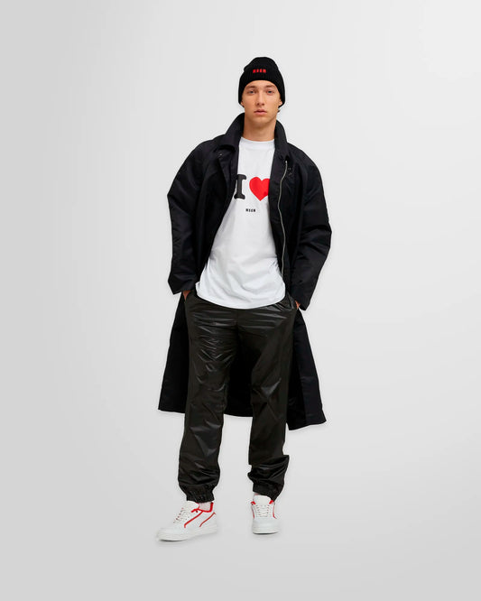 Model wearing MSGM Black Nylon Track Pants paired with a white T-shirt for a casual yet stylish look.”