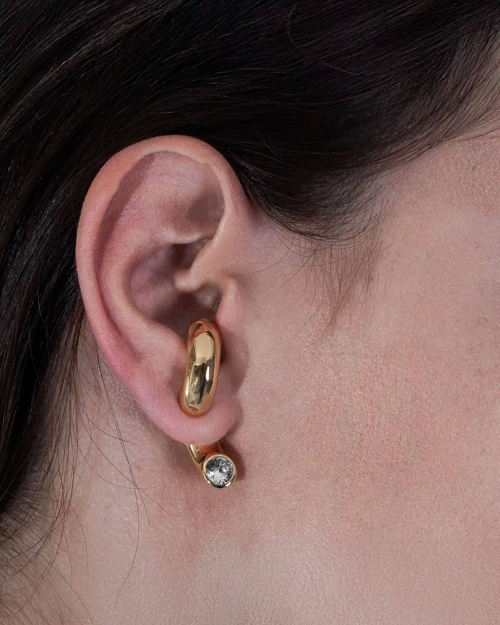 Model wearing Alan Crocetti Clear Blown Peekaboo single earring in gold vermeil with zirconia stone