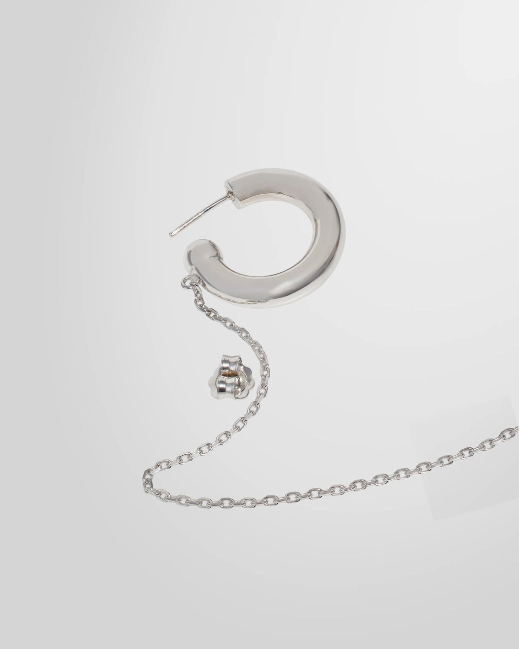 Detail of the Alan Crocetti Mood Ear Set earring highlighting the rhodium finish and chain attachment.