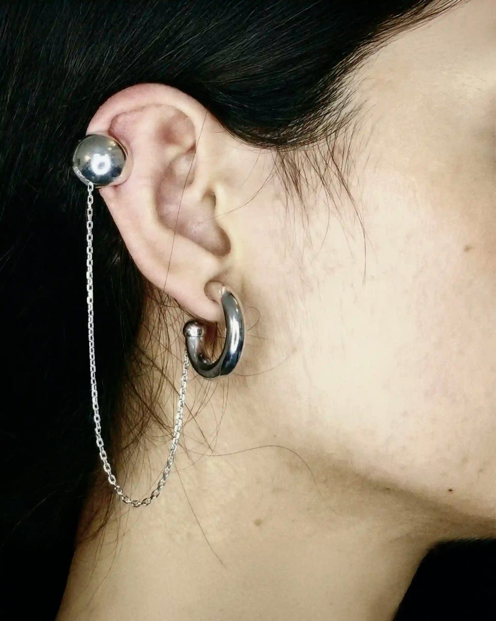 Model wearing the Alan Crocetti Mood Ear Set earring in silver with rhodium vermeil.