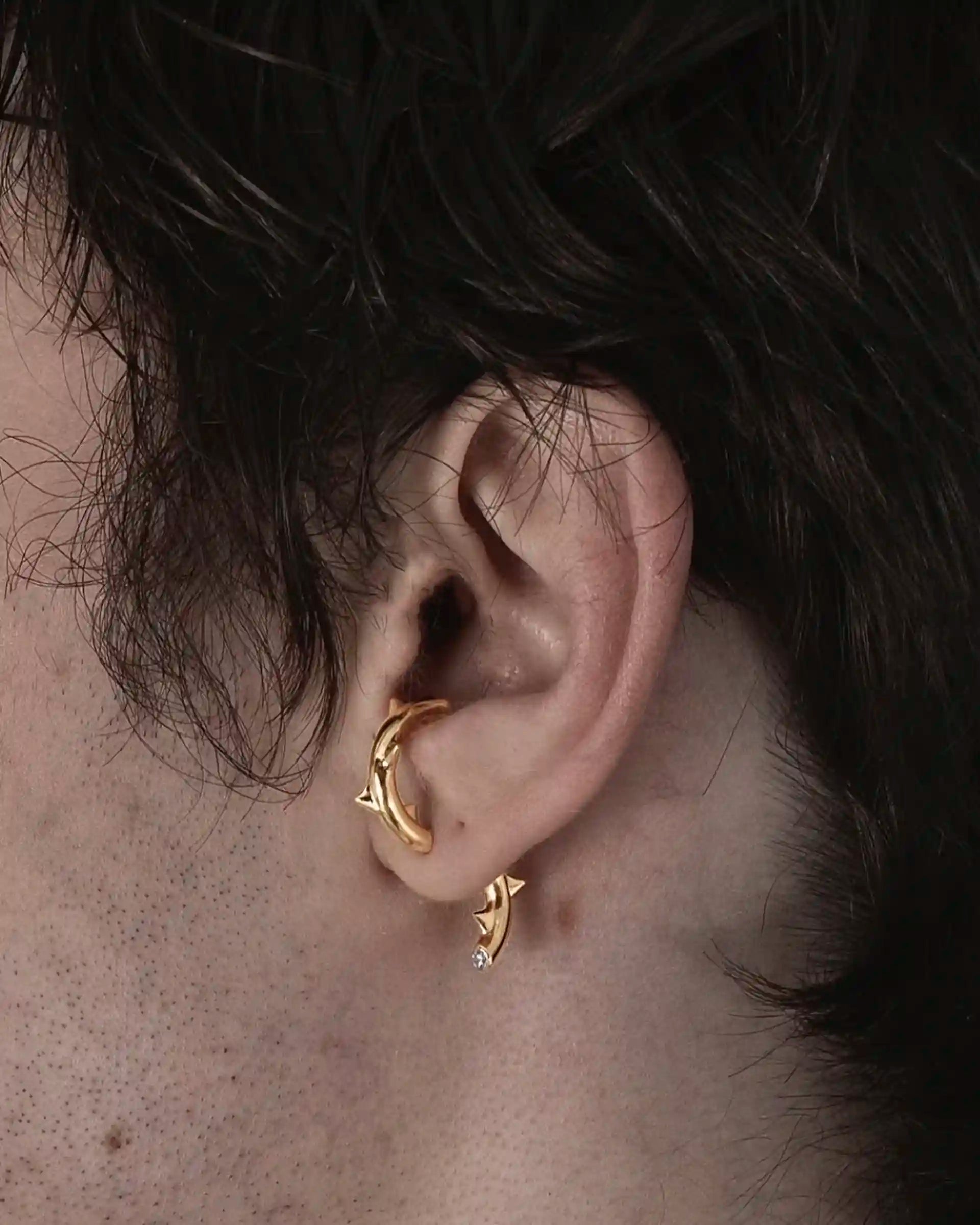 Model wearing the single Alan Crocetti Peekaboo Thorn Earring with zirconia stone and gold vermeil.