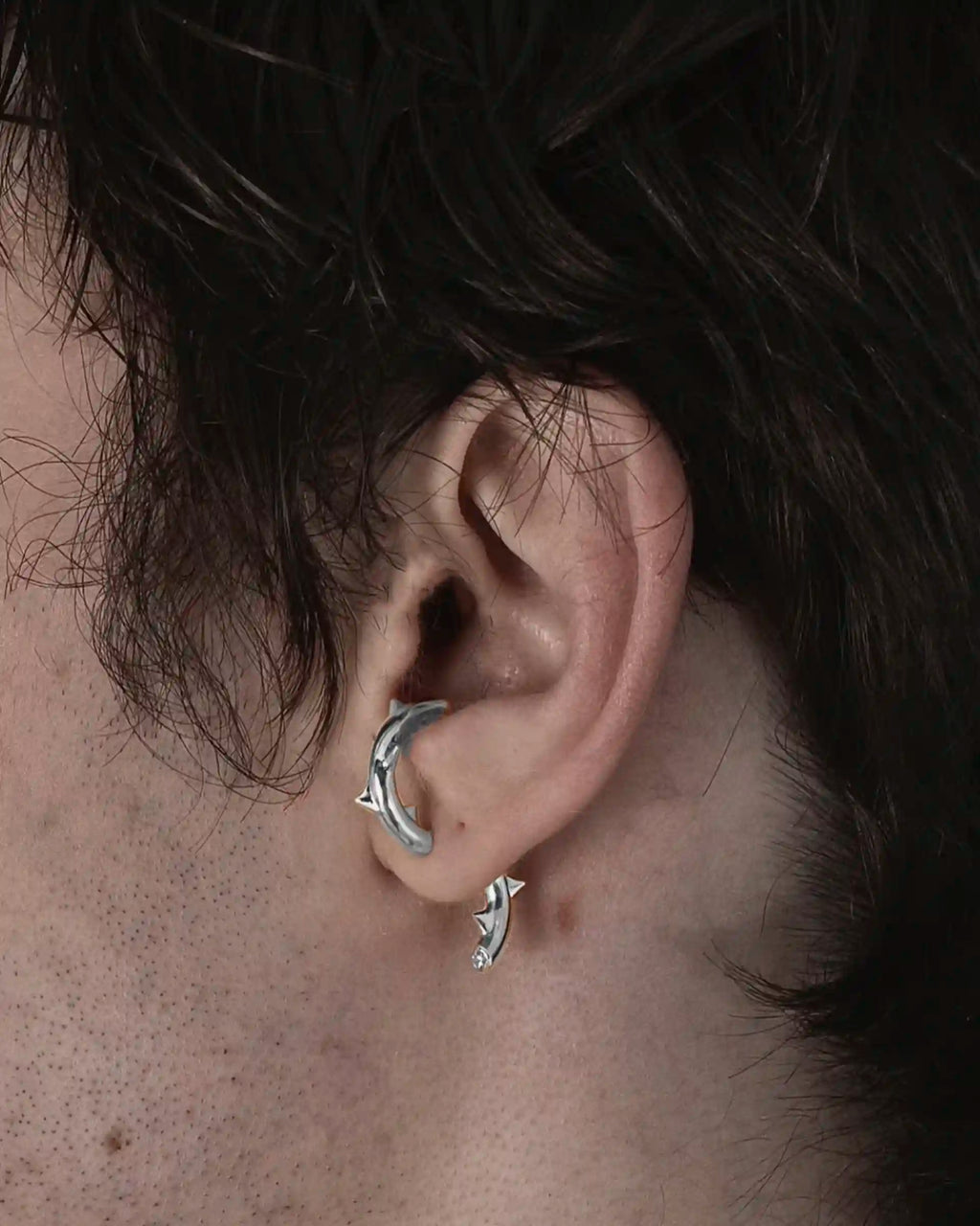 Model wearing the single Alan Crocetti Peekaboo Thorn Earring in silver with rhodium vermeil and zirconia stone.