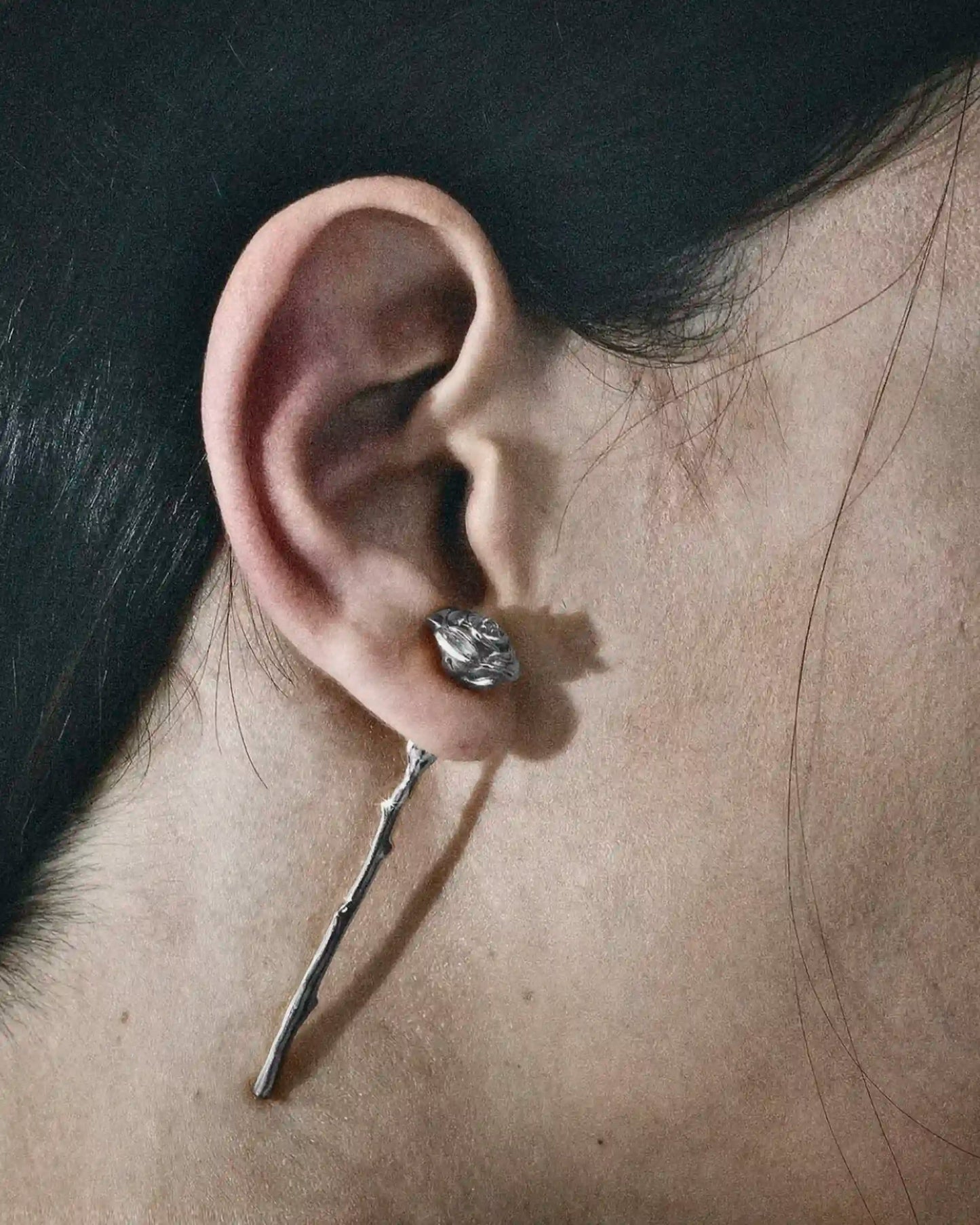 Model wearing the Alan Crocetti Rose Earring silver with rhodium vermeil.