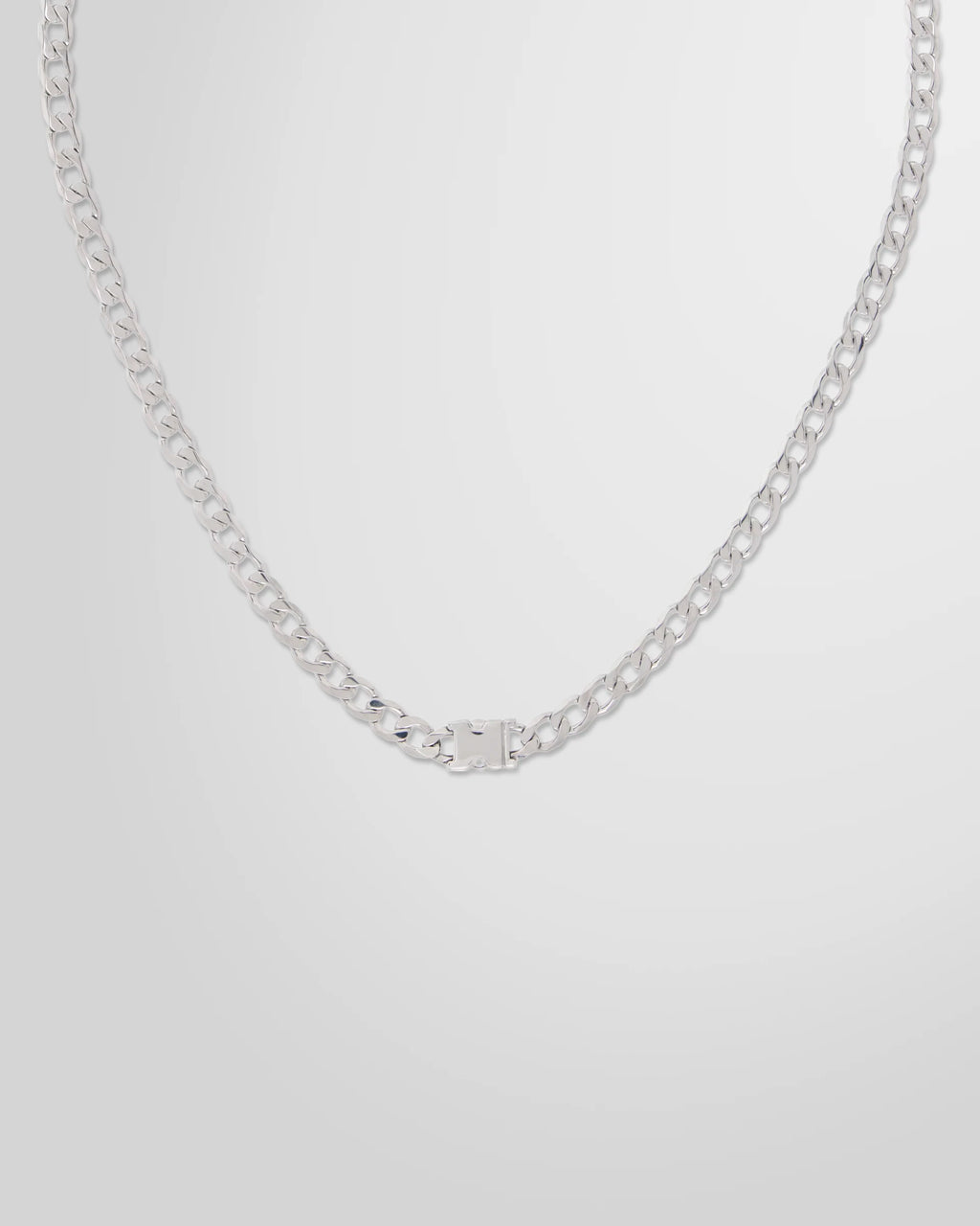 Detail view of the press-release hardware on the Alan Crocetti Unity Curb Chain Necklace.