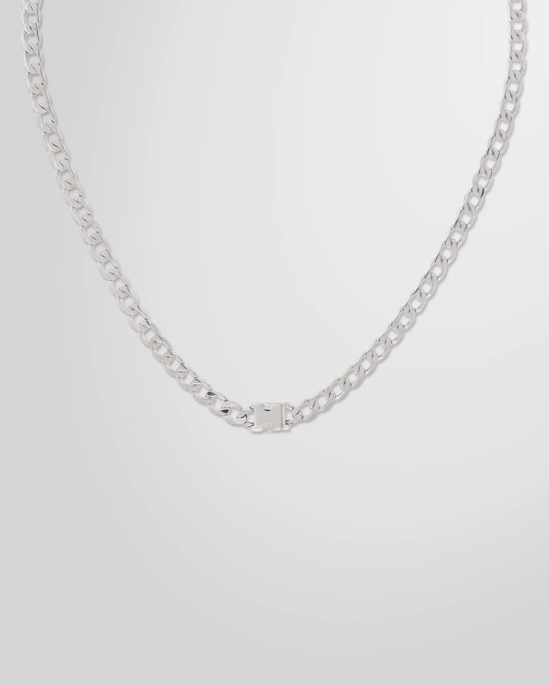 Detail view of the press-release hardware on the Alan Crocetti Unity Curb Chain Necklace.