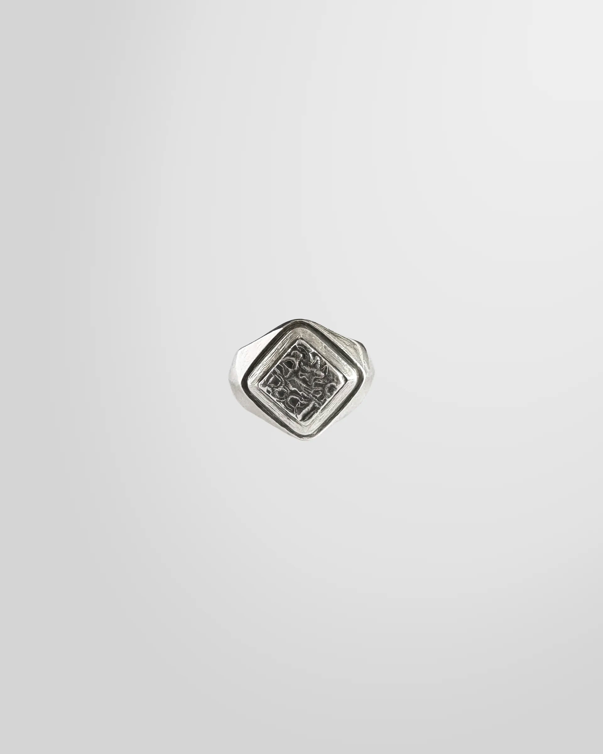Top view of the Johnny Ramli Carved Signet Ring, showing the diamond-shaped face and intricate pattern.