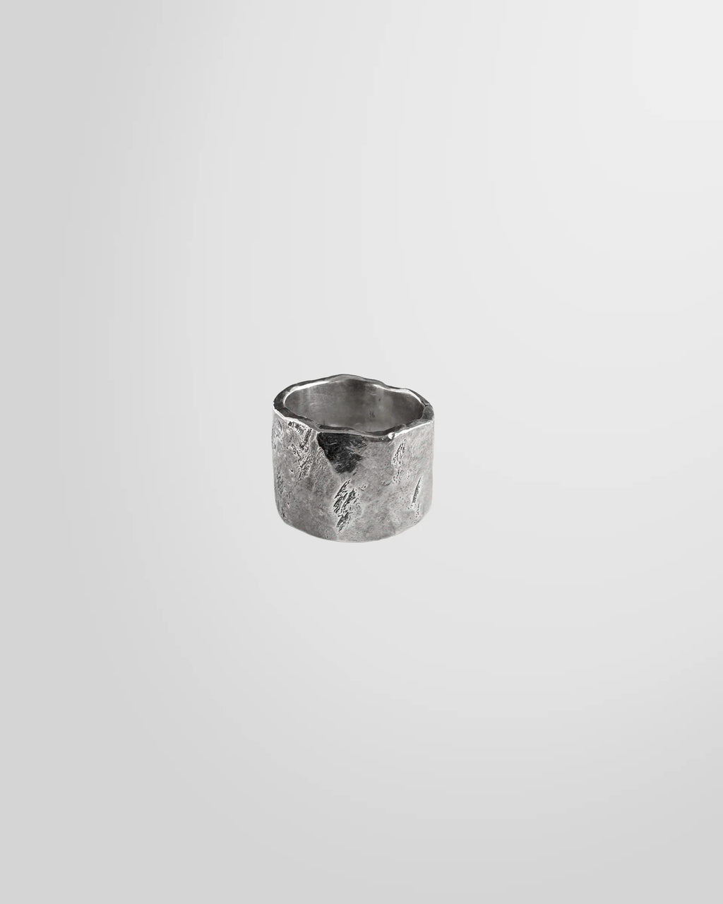Close-up detail of the hand-forged texture on the Johnny Ramli band ring.