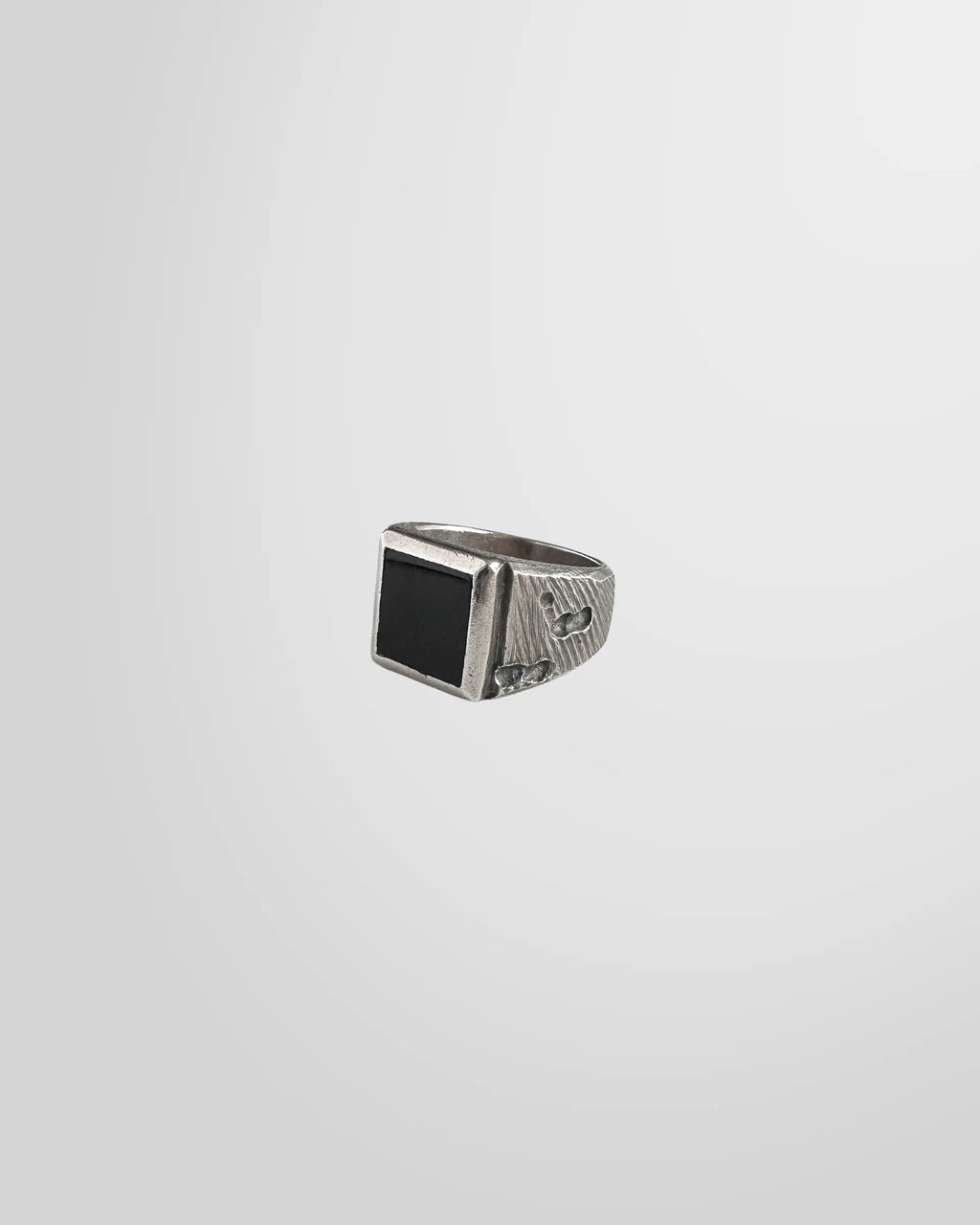 A close-up of the oxidised finish and texture on the Johnny Ramli signet ring.