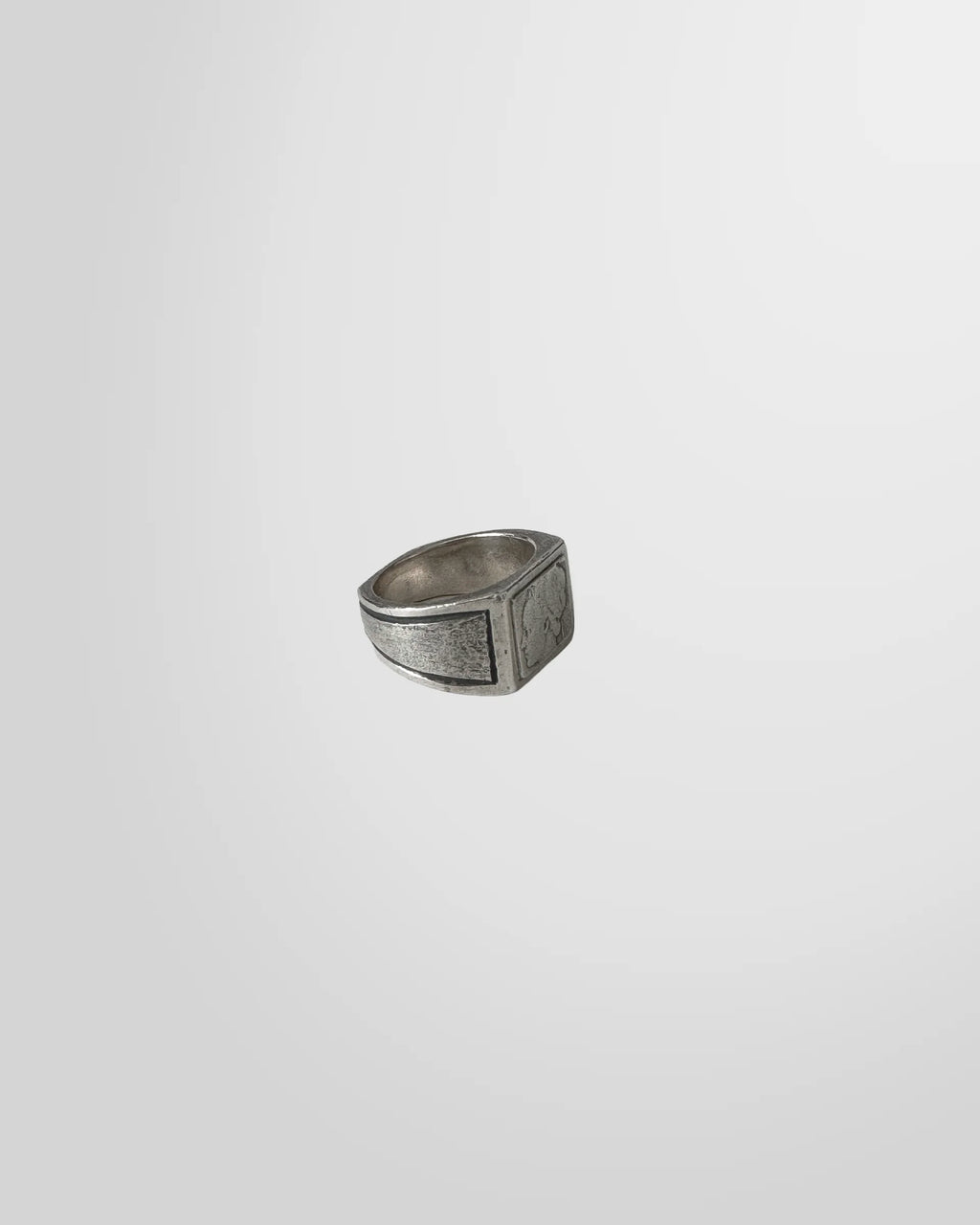 Side profile of the Johnny Ramli signet ring, highlighting the textured, oxidized finish of the silver band.