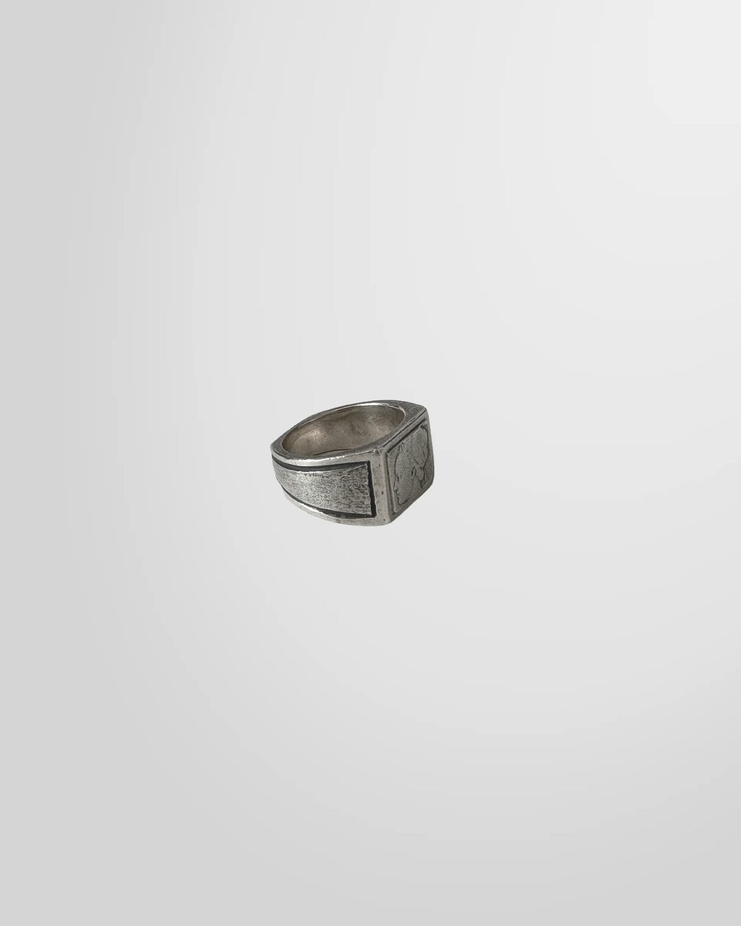 Side profile of the Johnny Ramli signet ring, highlighting the textured, oxidized finish of the silver band.