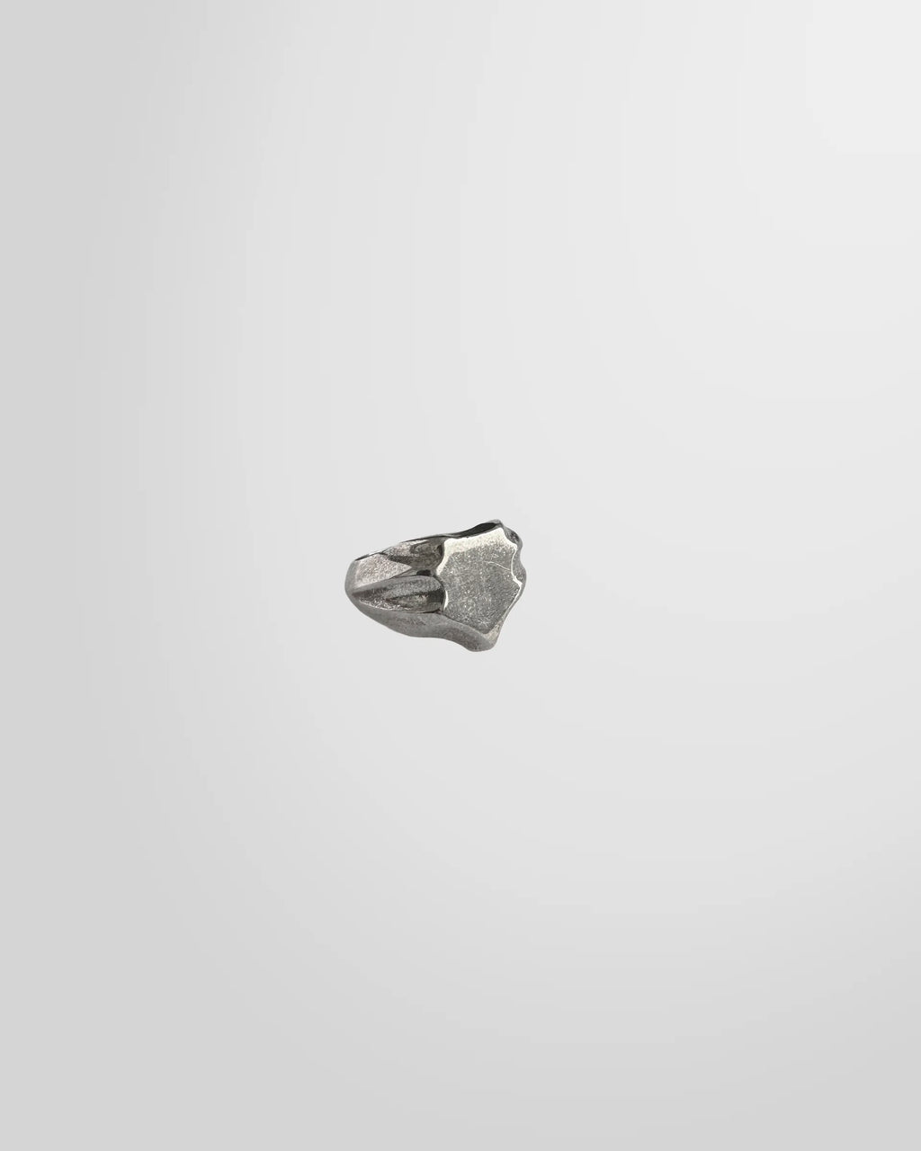 Side view of the Johnny Ramli Shield Signet Ring, showing its crest shape and oxidized face.