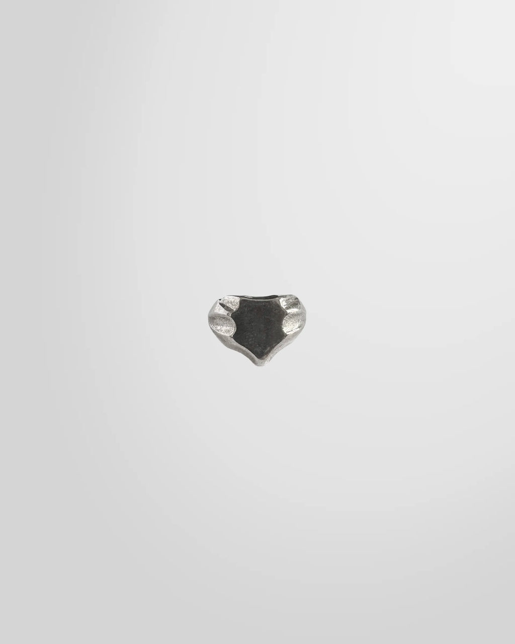 Top view of the Johnny Ramli Shield Signet Ring, showing its crest shape and oxidized face.