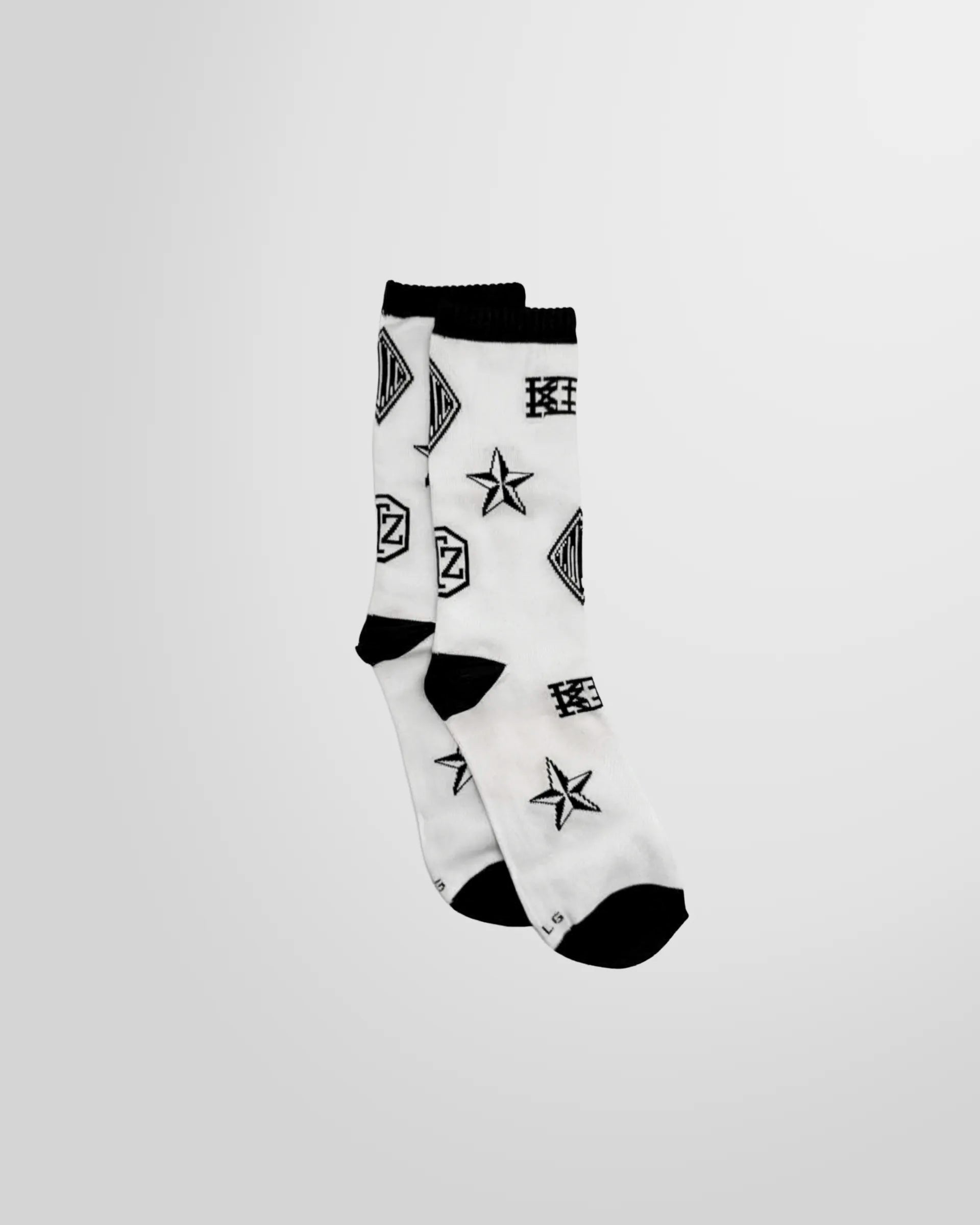 Full view of the Monogram Print Socks in white from KTZ featuring black artwork printed.