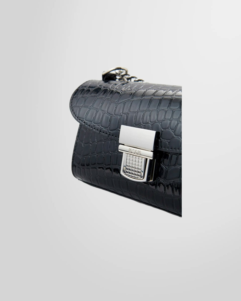 Side profile of the MSGM Black Croc-Embossed Cross-body Bag showing the flap and buckle.