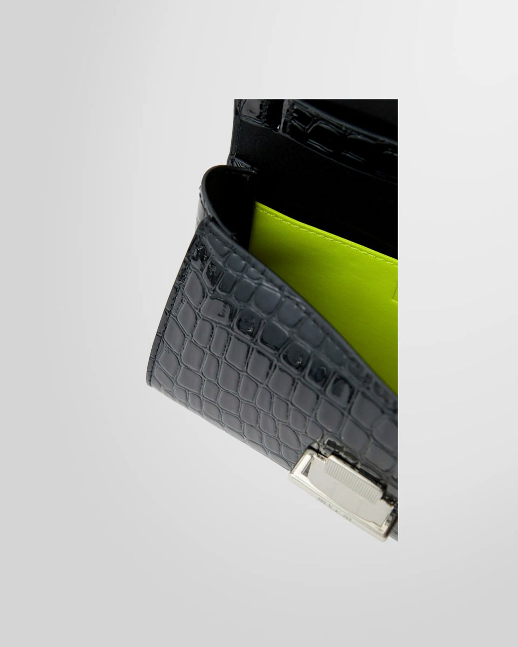 Close-up of the crocodile-embossed texture and snap buckle on the MSGM bag.