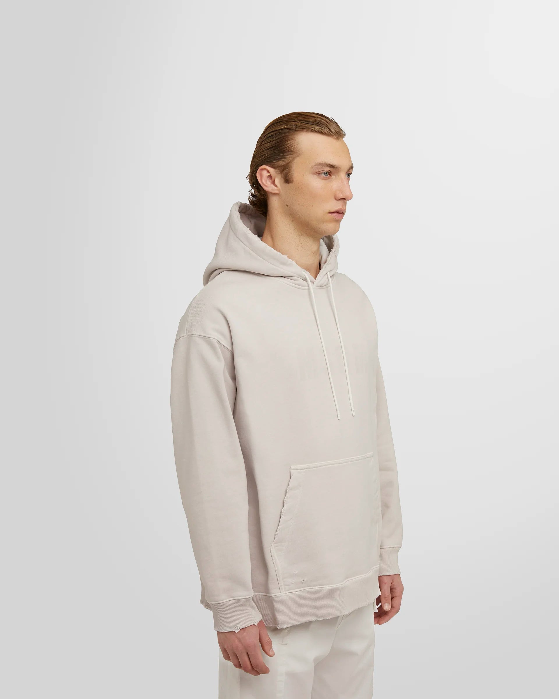 Model wearing the ash grey MSGM Distressed Logo Hoodie side view