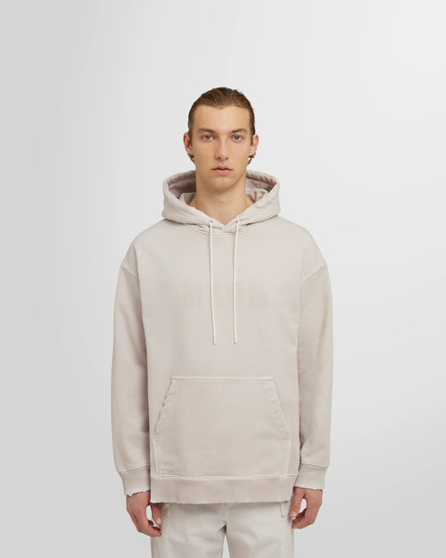 Model wearing the ash grey MSGM Distressed Logo Hoodie.