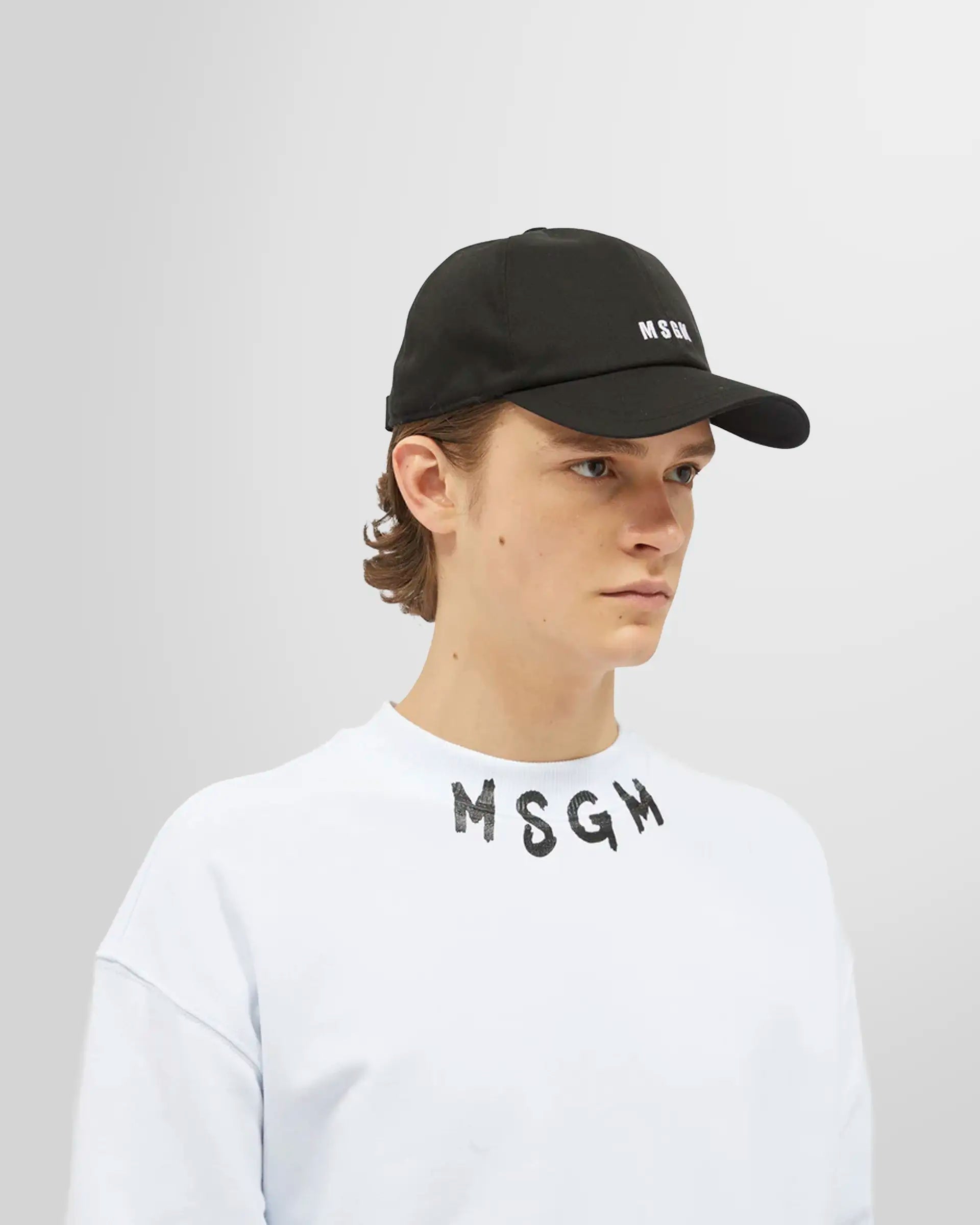 Model wearing the black MSGM embroidered logo baseball cap.