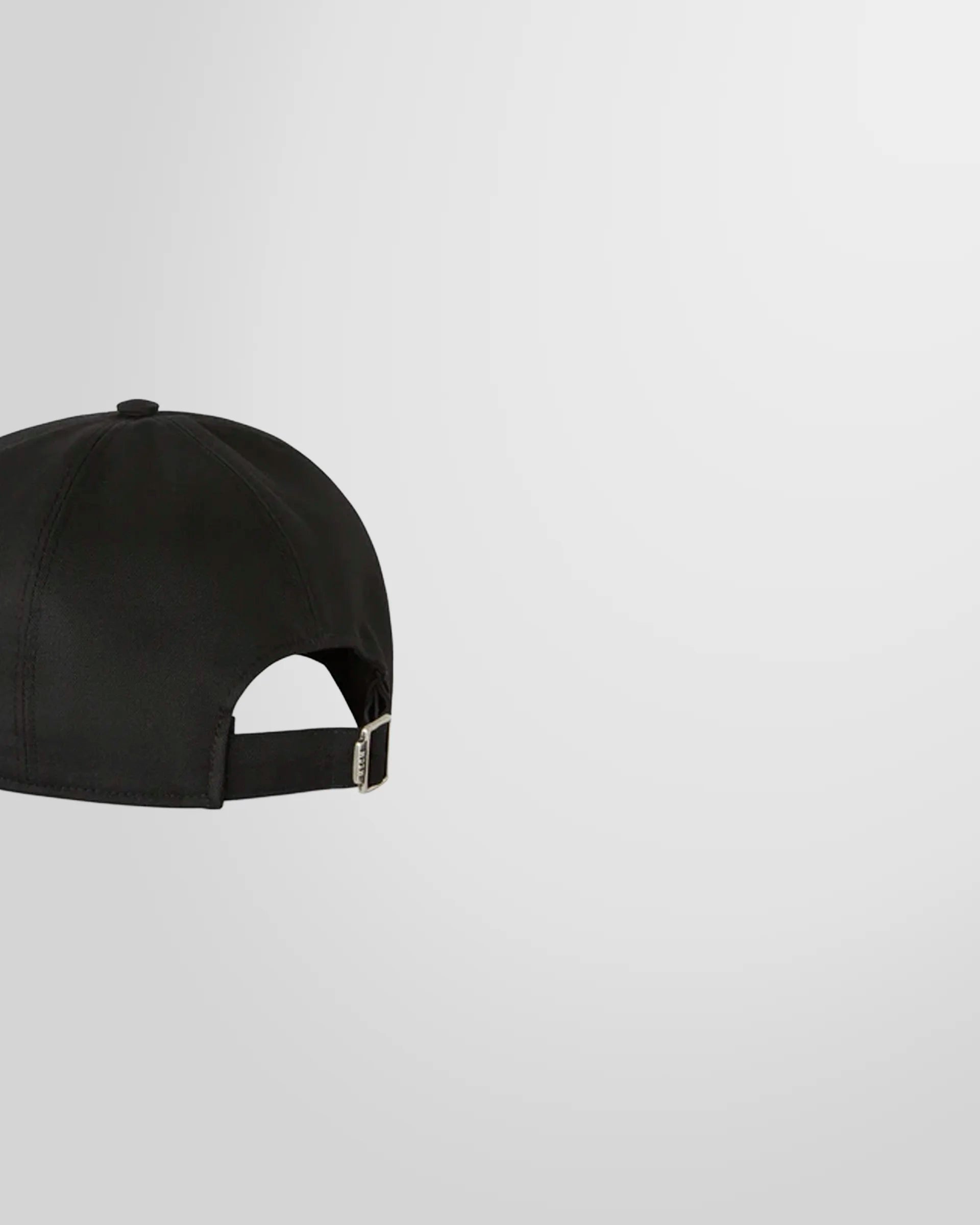 Side view of the Black MSGM cotton baseball cap showing the adjustable buckle.
