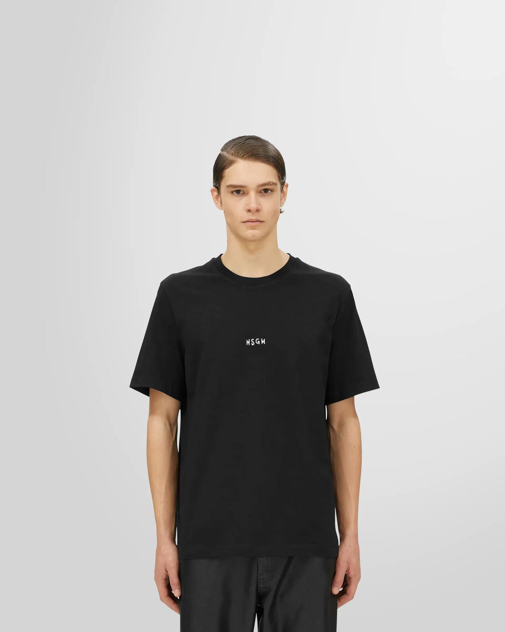 Front view of a model wearing the regular fit MSGM Micro Logo T-Shirt in black.