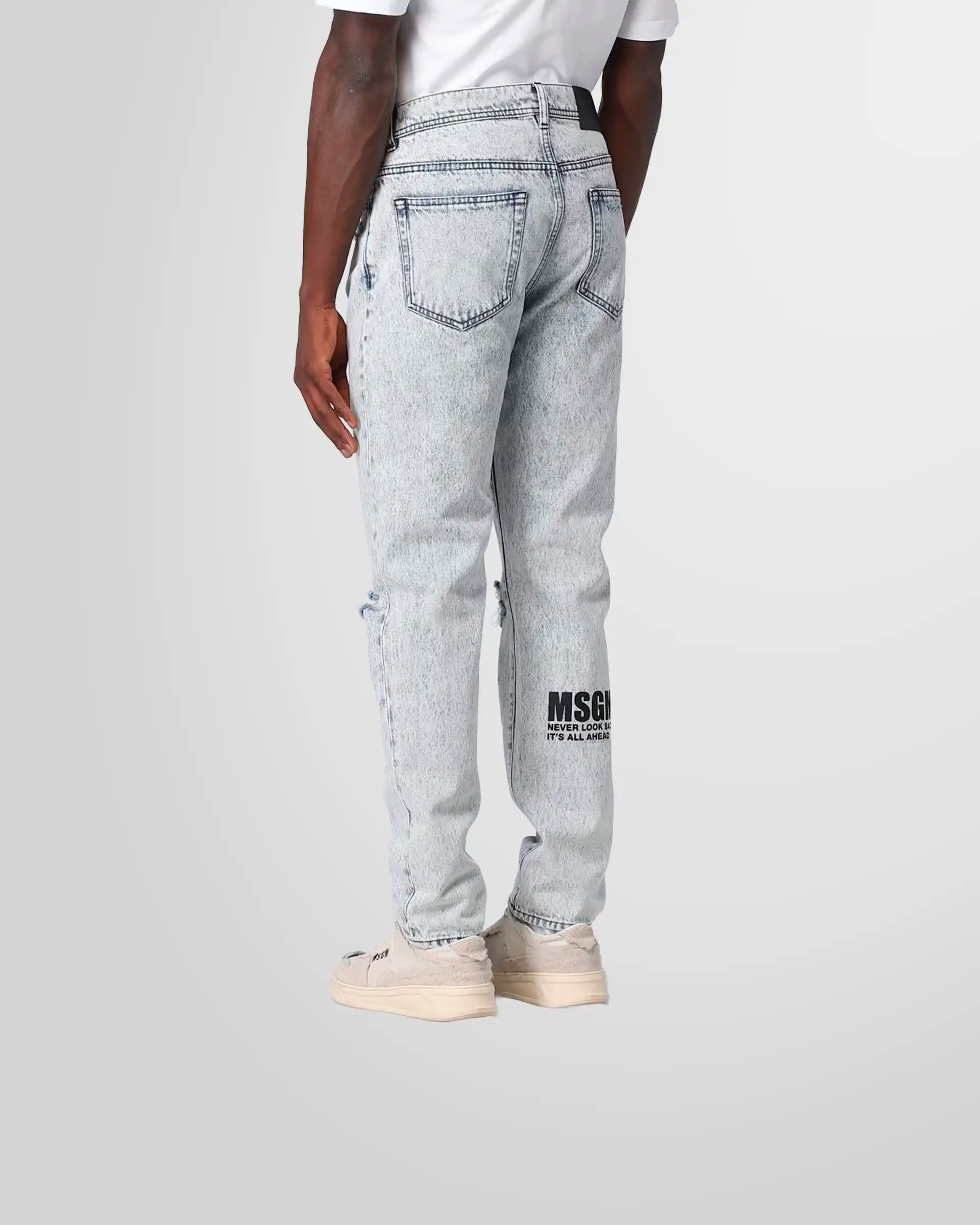 Back view of a model wearing the MSGM jeans, showing the pocket placement and the subtle logo print.