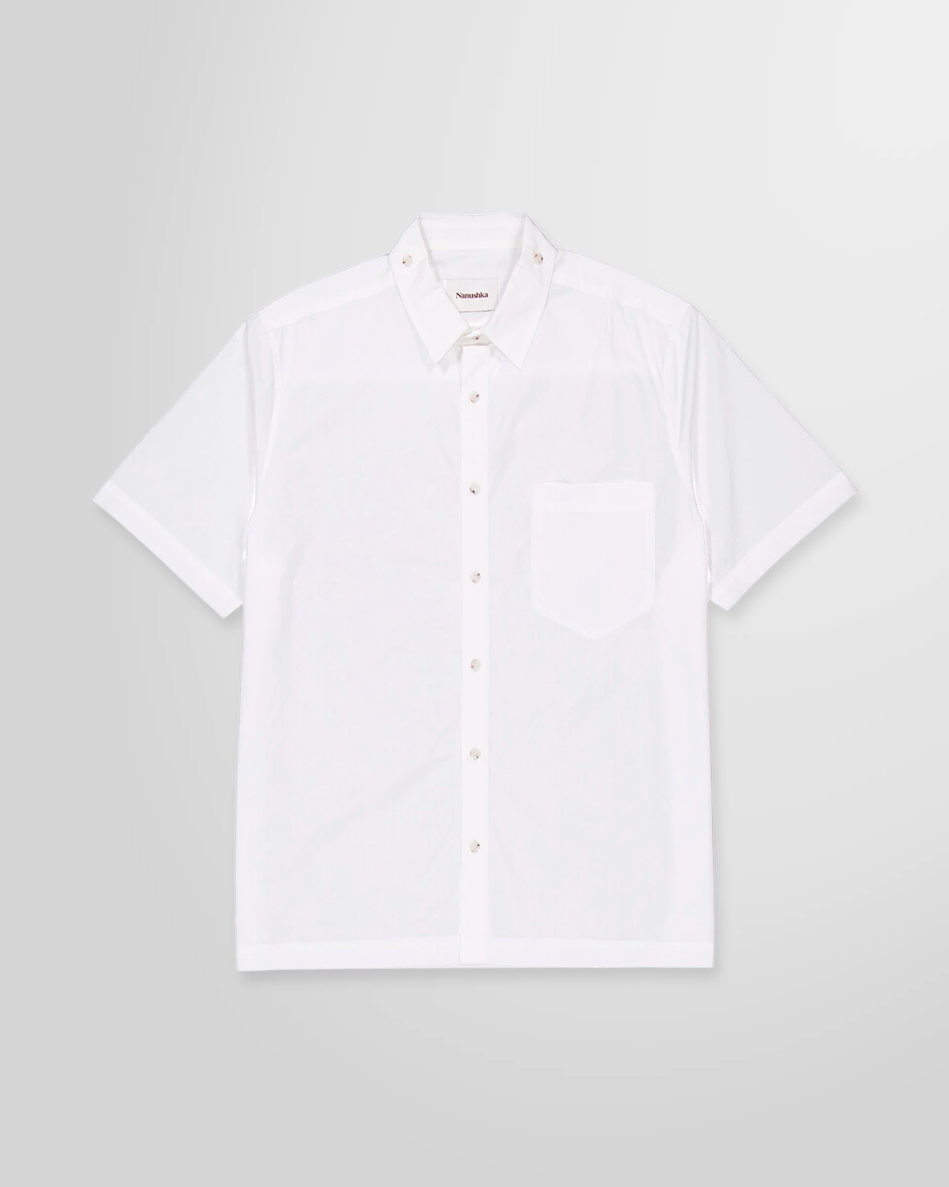 Front view of the Nanushka Adam short sleeve shirt in white cotton poplin with chest pocket and logo embroidery.