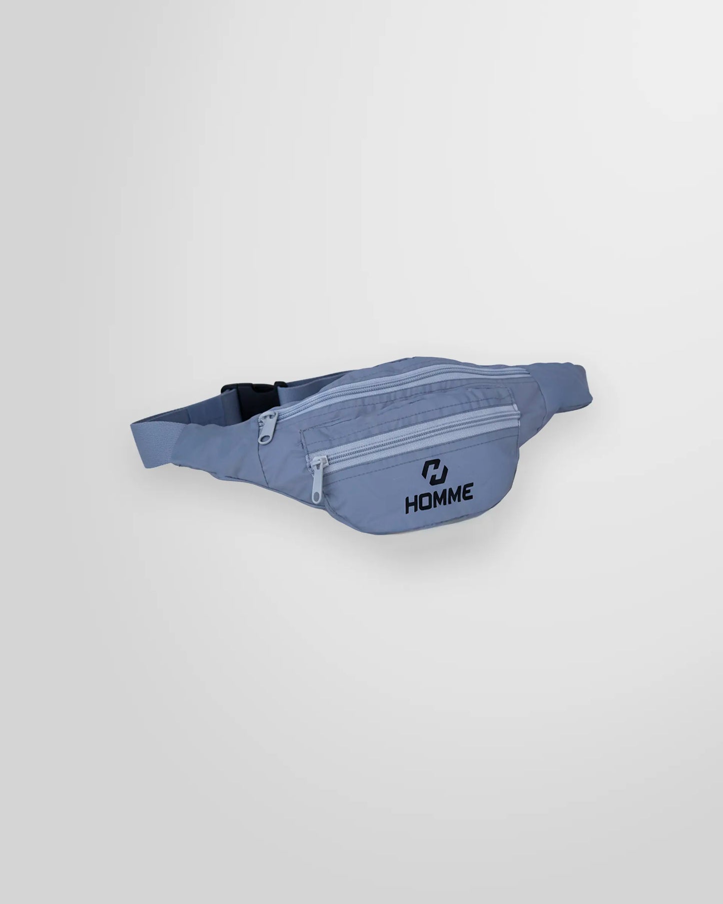 Angled view of the grey Not Guilty Homme belt bag, highlighting its multiple compartments and lightweight structure.