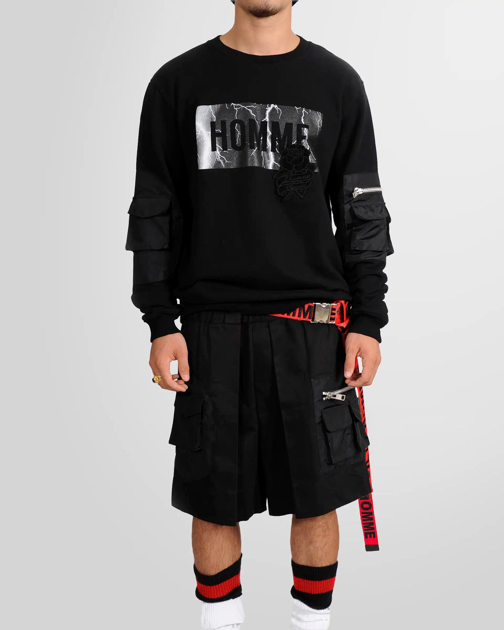 Model wearing the Red Not Guilty Homme belt with black embroidered logos and silver buckle.