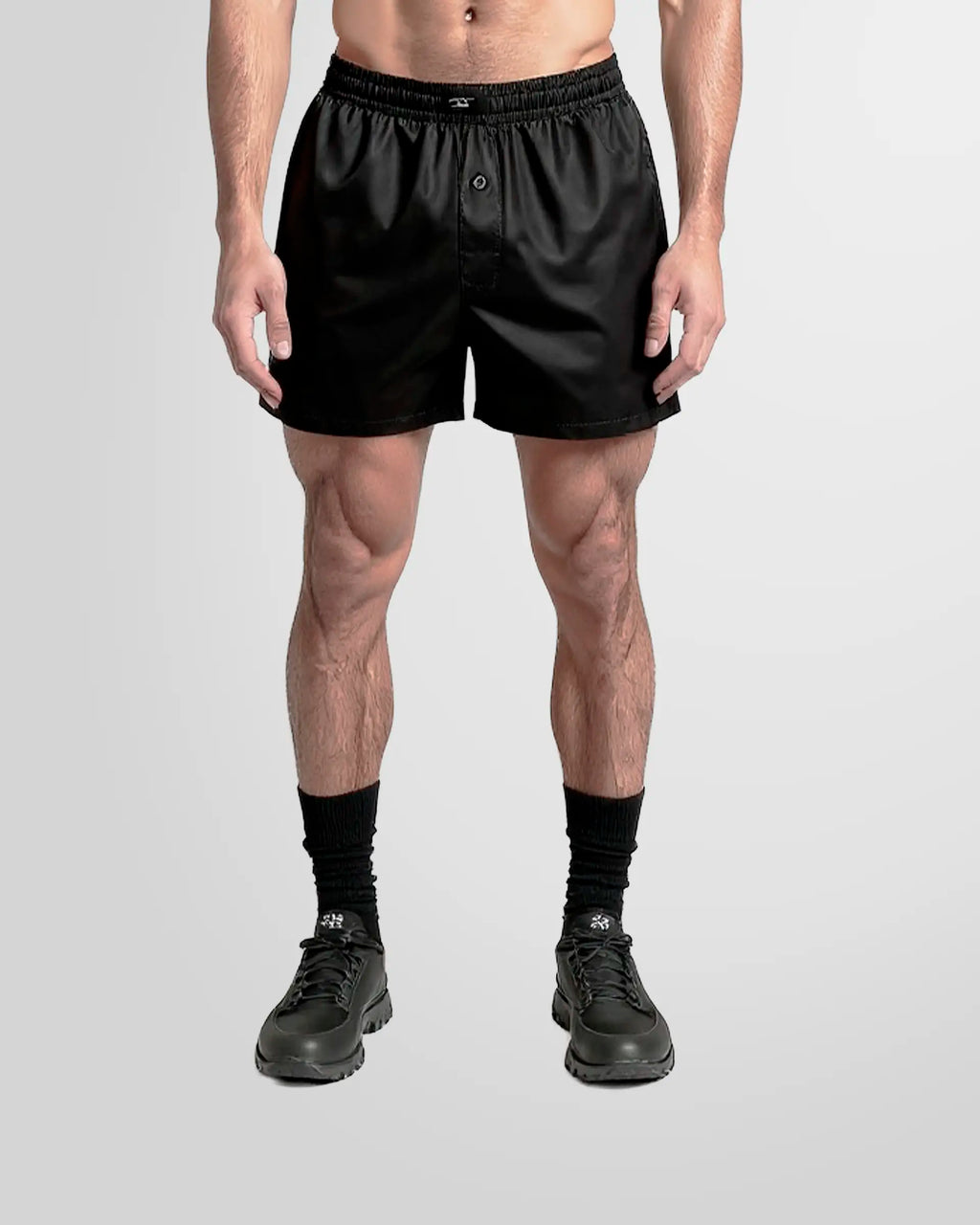 Model wearing the Not Guilty Homme Black Nylon Boxer Swim Shorts in lightweight fabric.