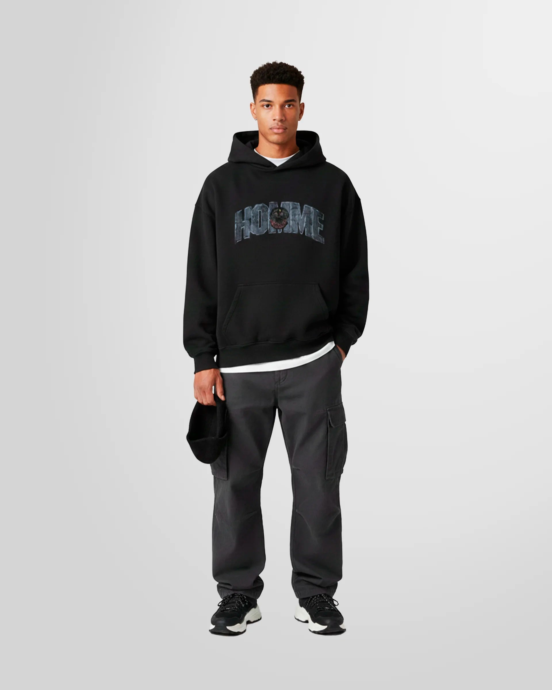 Model wearing the black college hoodie by Not Guilty Homme.