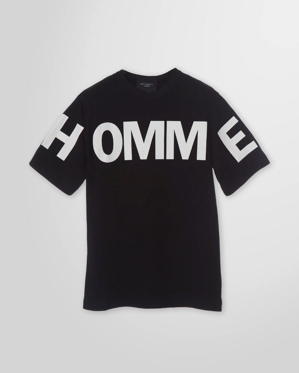 Front view of the Not Guilty Homme graphic t-shirt in black, showcasing the relaxed fit and high-contrast 'HOMME' print in white.