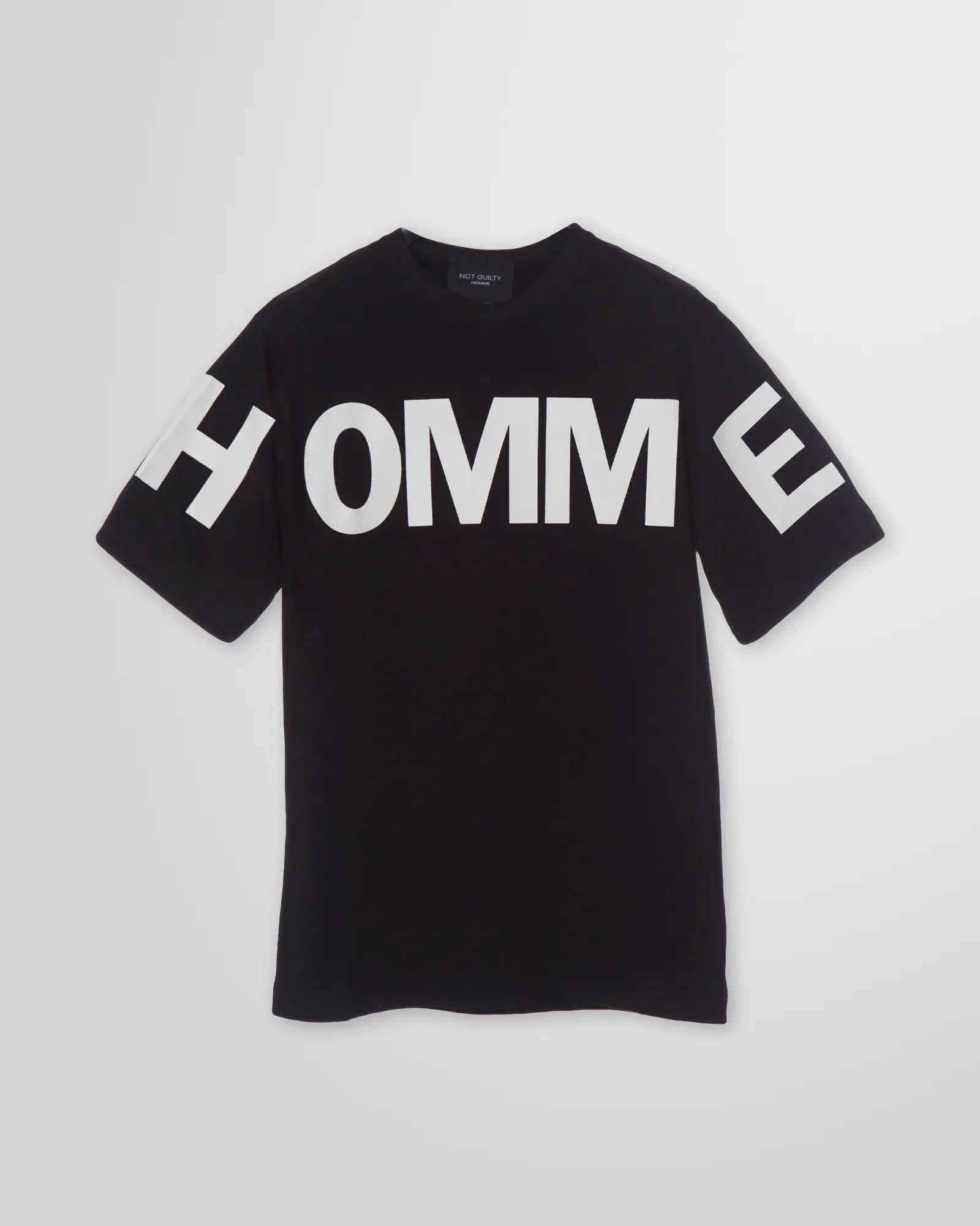 Front view of the Not Guilty Homme graphic t-shirt in black, showcasing the relaxed fit and high-contrast 'HOMME' print in white.