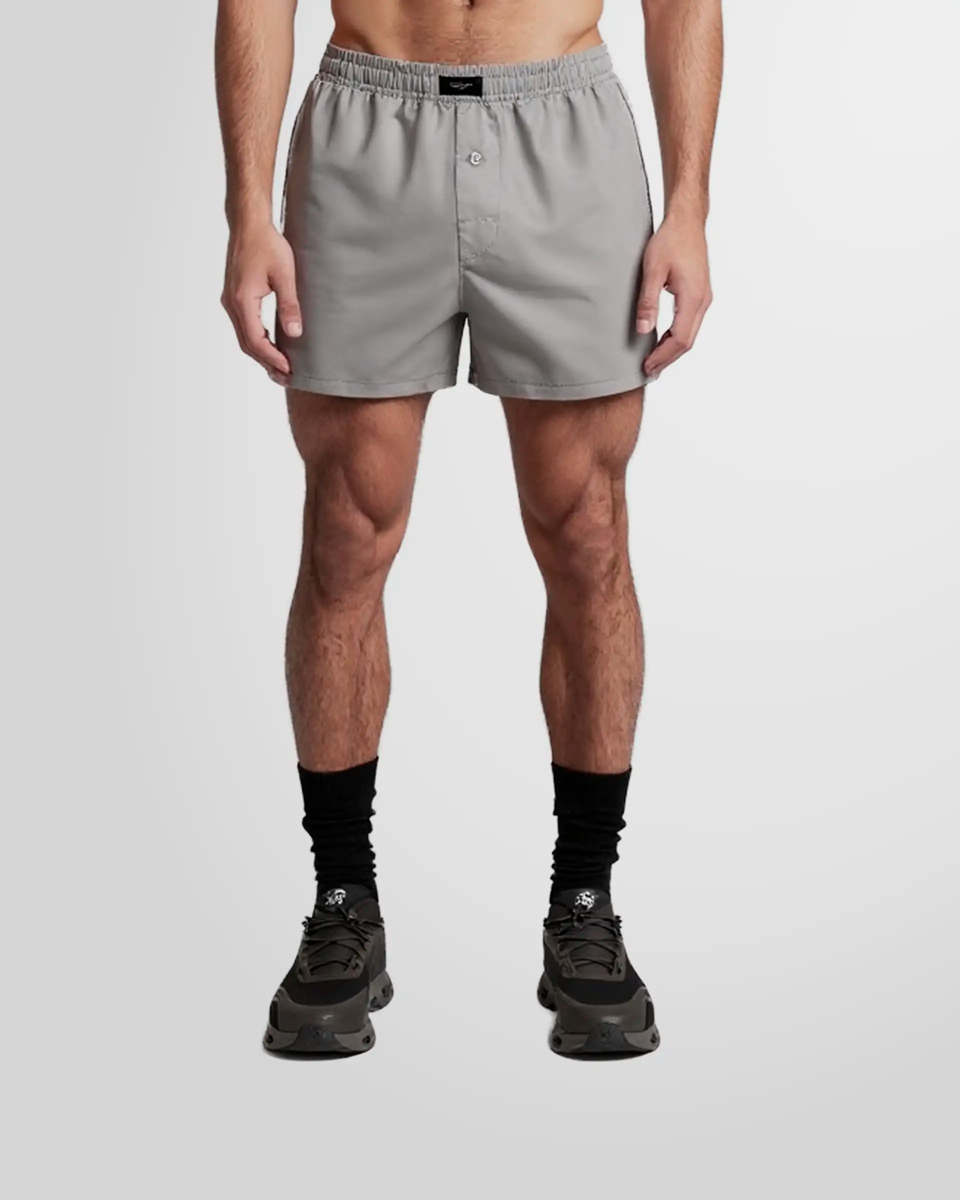 Front view of a model wearing the Not Guilty Homme Grey Boxer Swim Shorts in lightweight Nylon.