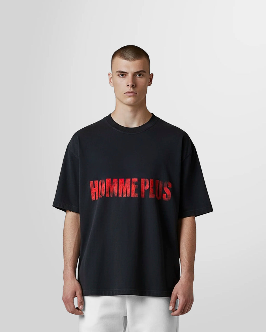 Model wearing the black Homme Plus Logo T‑Shirt by Not Guilty Homme.