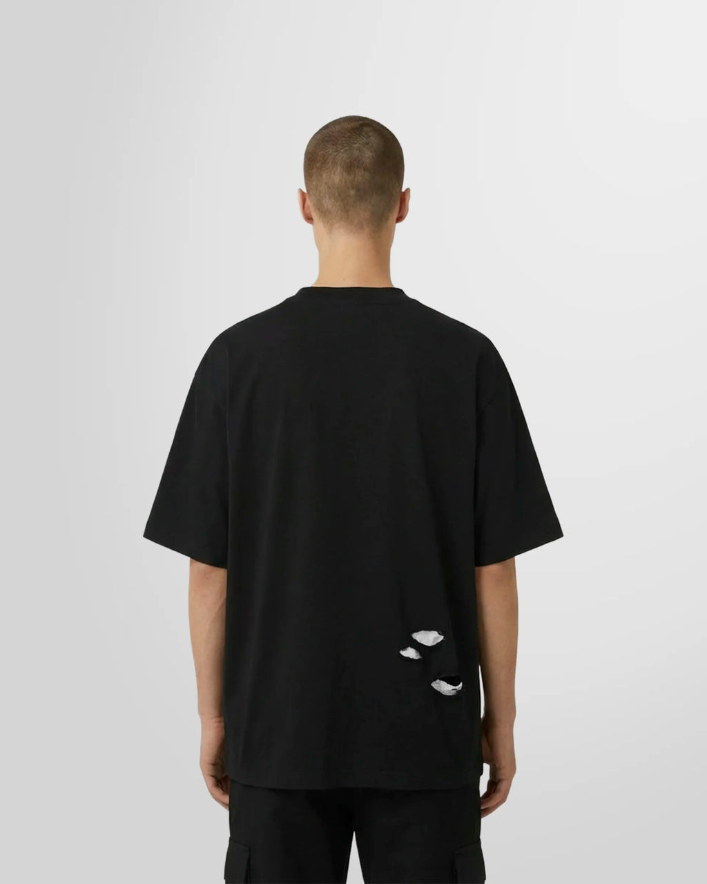 Back view of a model wearing the black Journey Printed T‑Shirt with “The Journey of Desire” HOMME graphic.