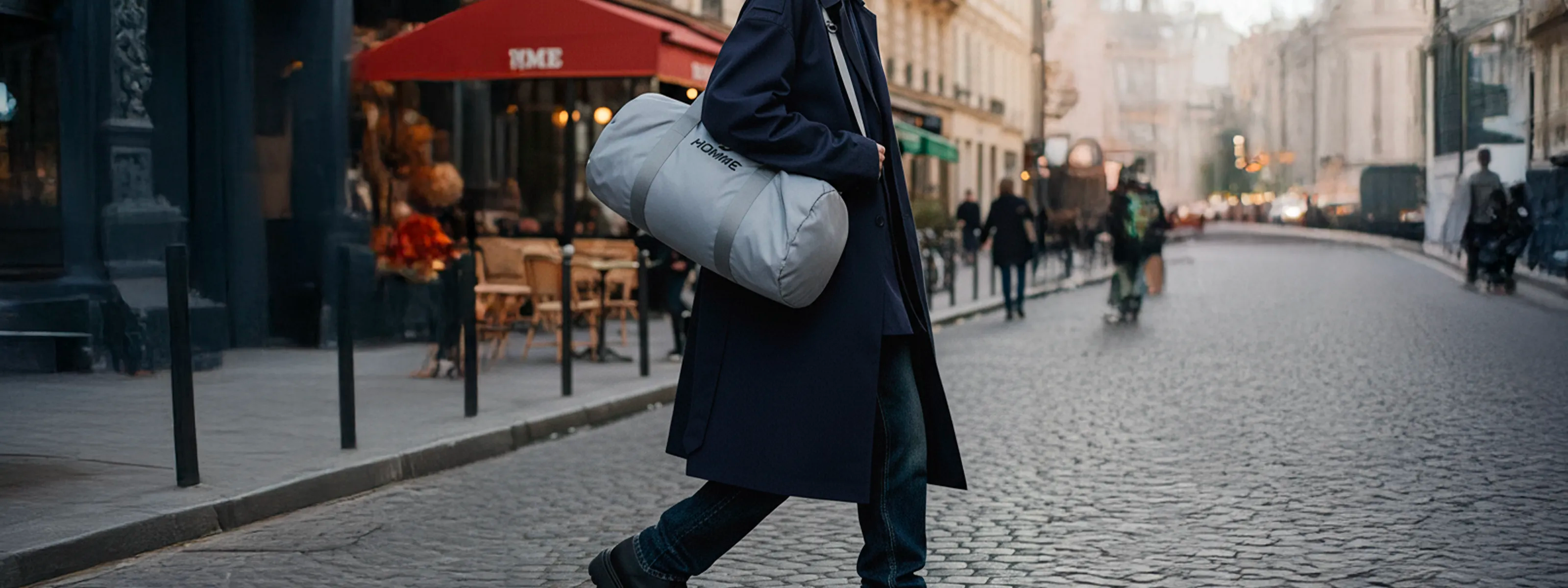 Not Guilty Homme — New In AW25: model with grey Sport Bag walking in the city