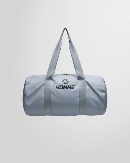 Full studio view of the Not Guilty Homme lightweight sport bag in grey, showcasing its minimalist design.