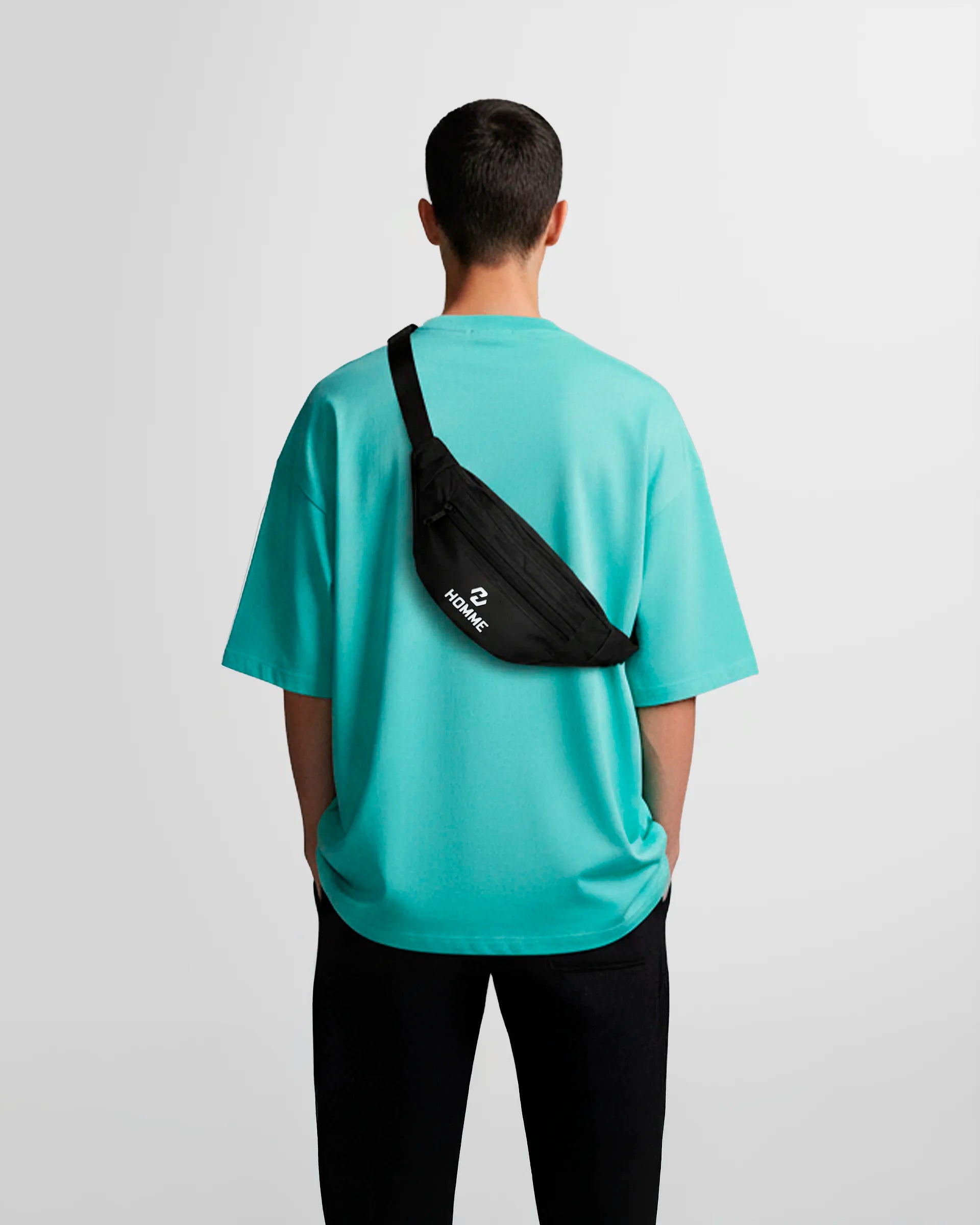 Model wearing the Not Guilty Homme technical belt bag in black lightweight nylon.