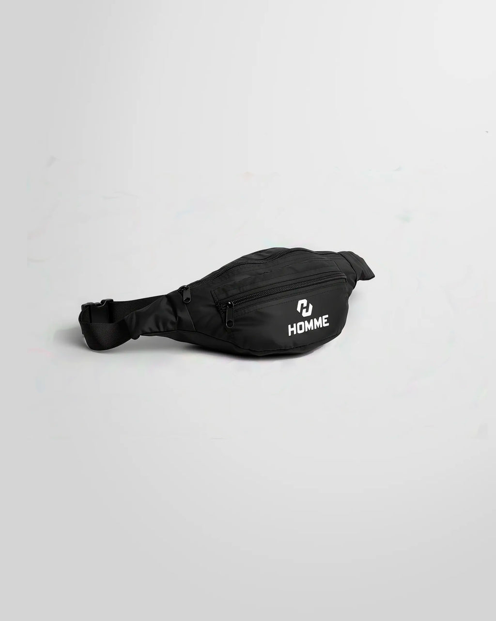 Side view of the Not Guilty Homme technical belt bag in black with whhite logo printed in the front pocket