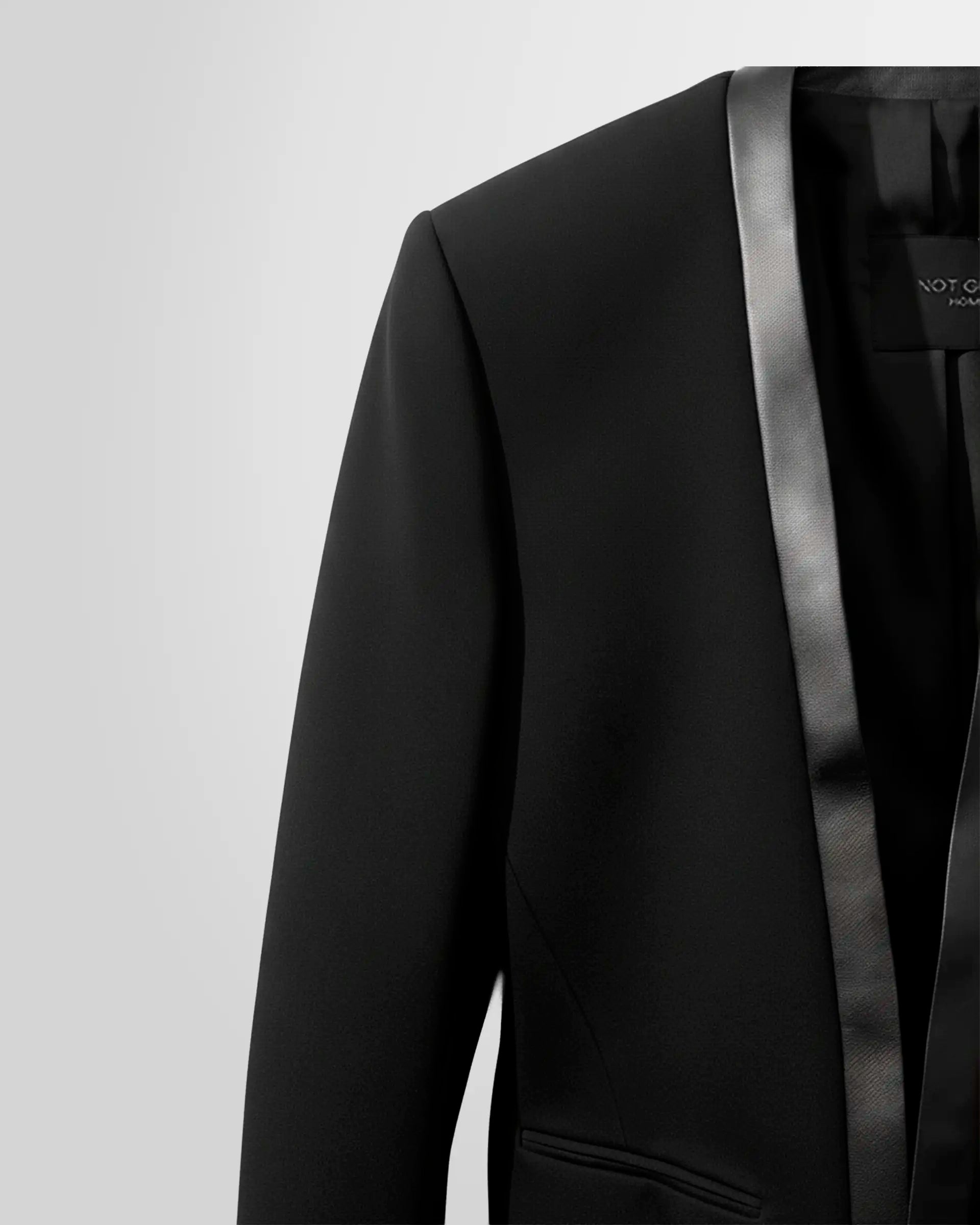Close‑up of the Not Guilty Homme black wool blazer showing the nappa leather lapel.
