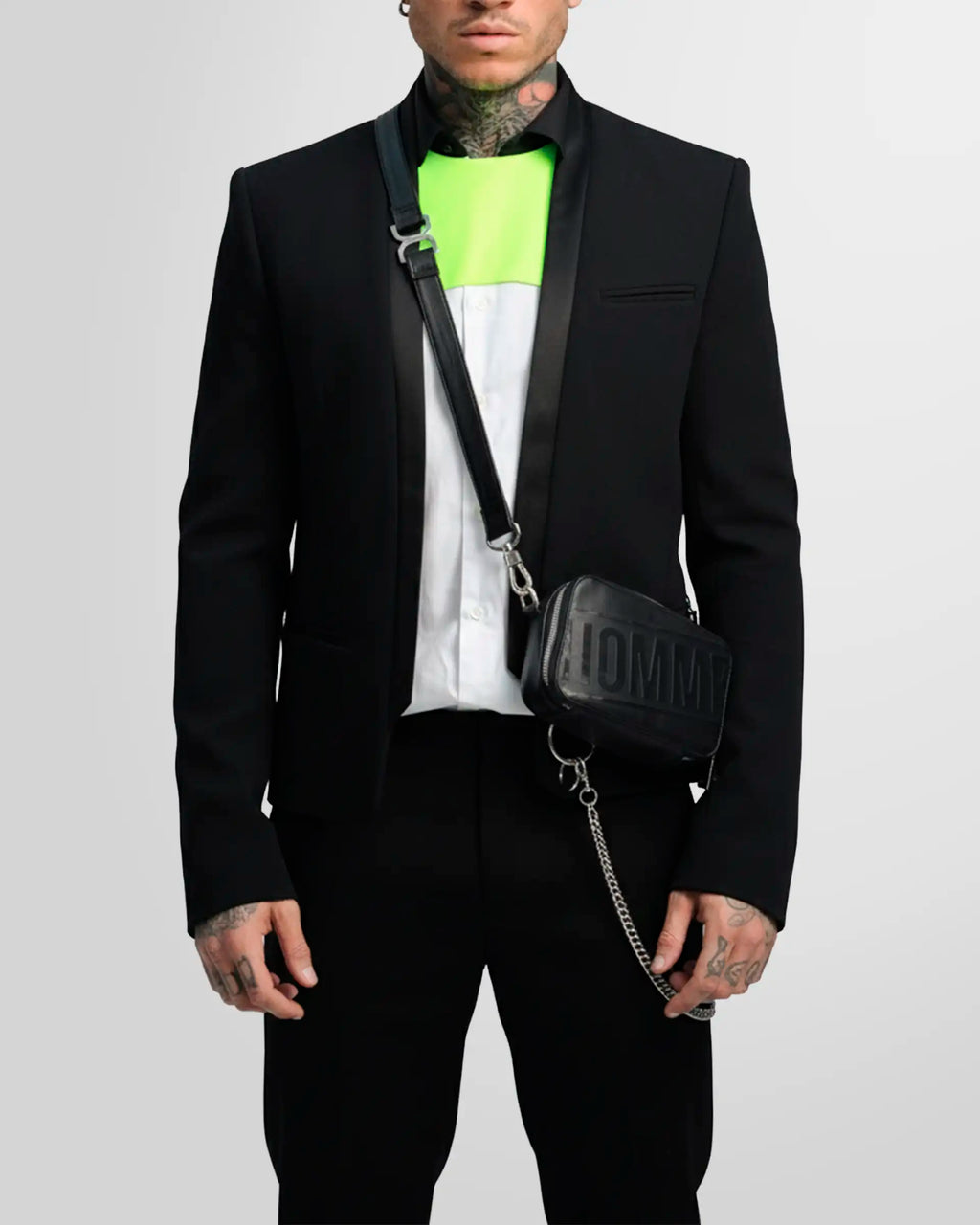 Detail shot of the blazer's straight cuff with three covered buttons as worn by a model.