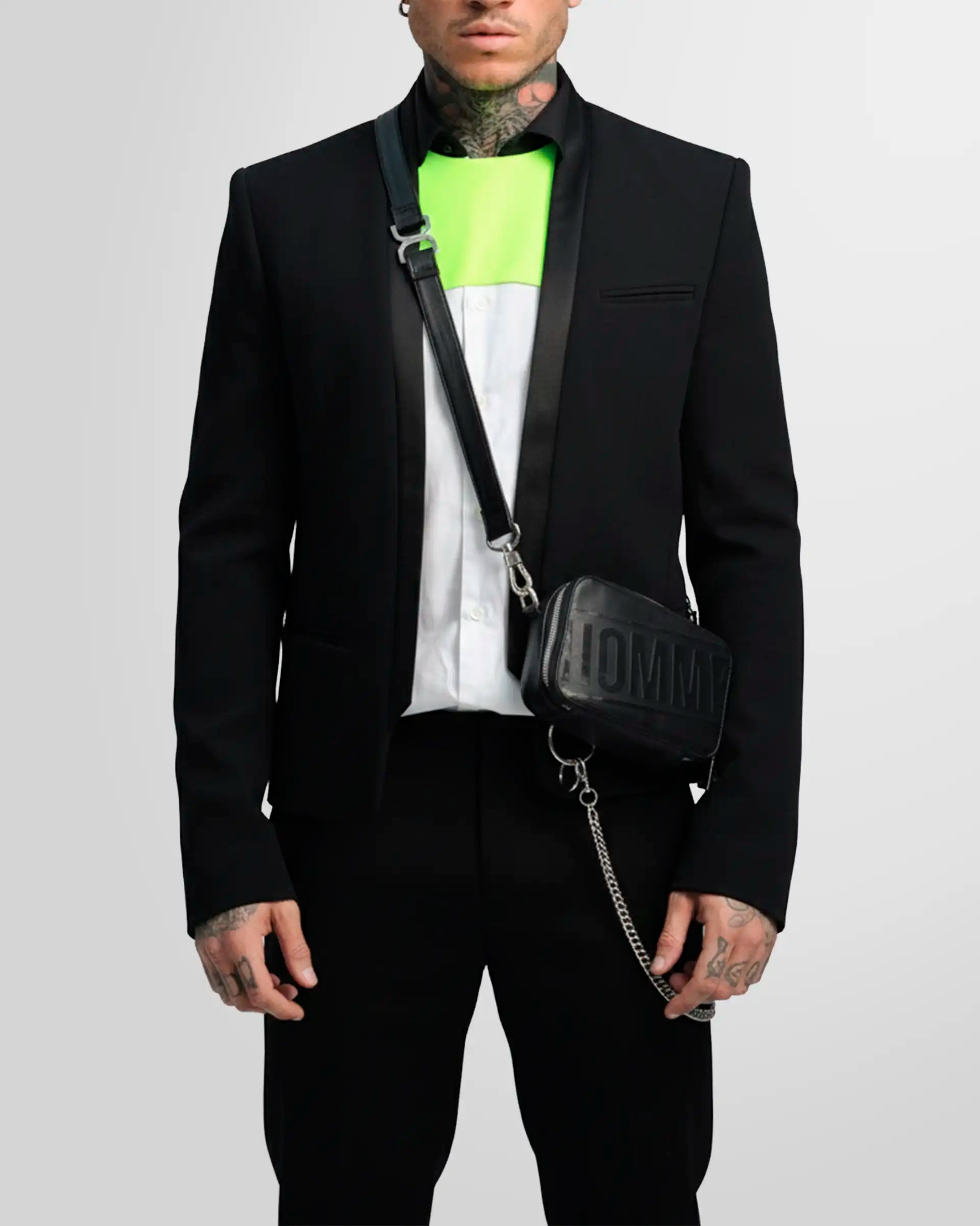 Detail shot of the blazer's straight cuff with three covered buttons as worn by a model.