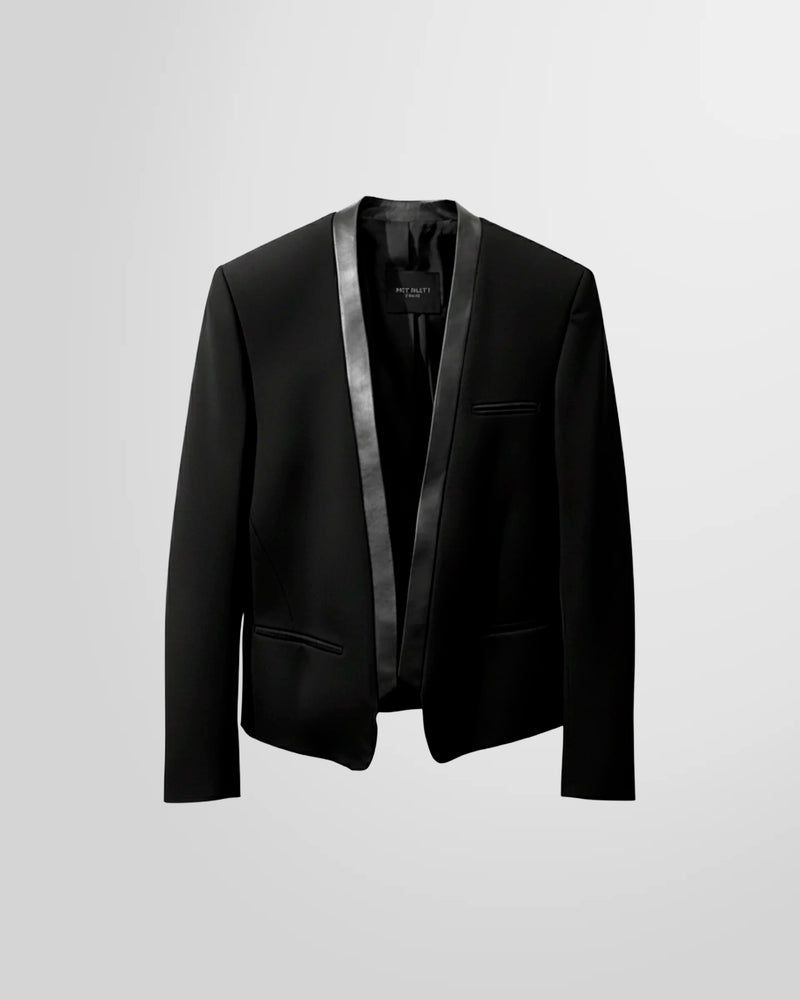 Studio shot of the Not Guilty Homme wool blazer, showing the nappa leather lapel, straight cut, and cropped silhouette.
