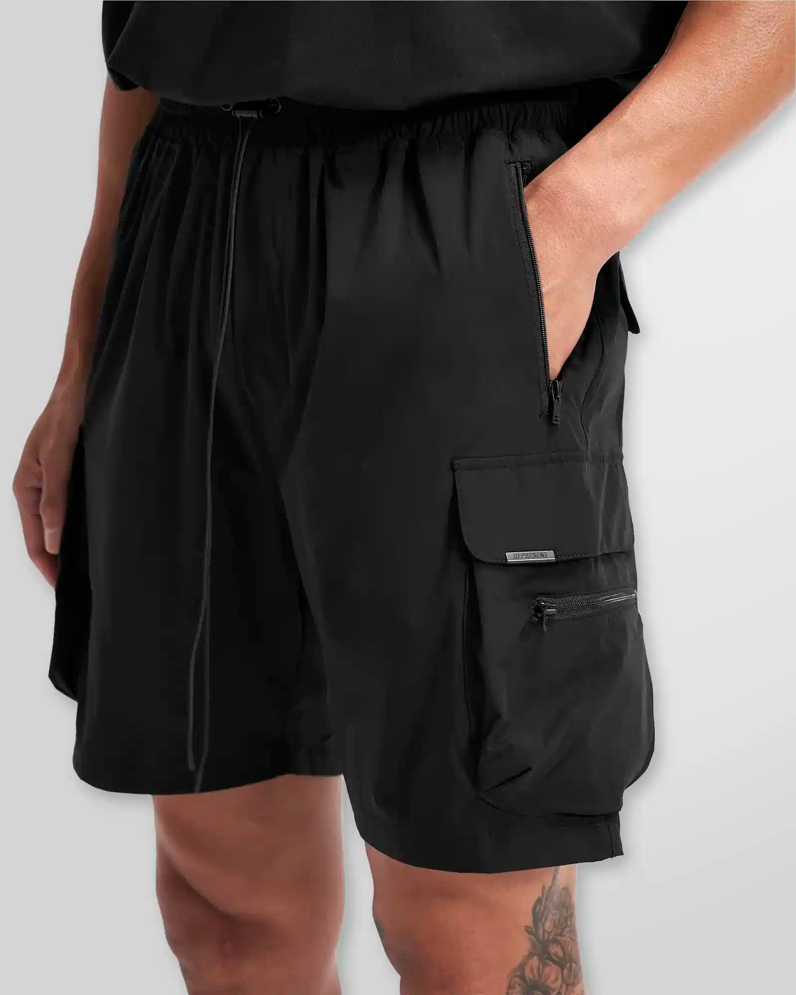 Close-up of the 4-way stretch technical nylon and zip hardware on the Represent 247 shorts.